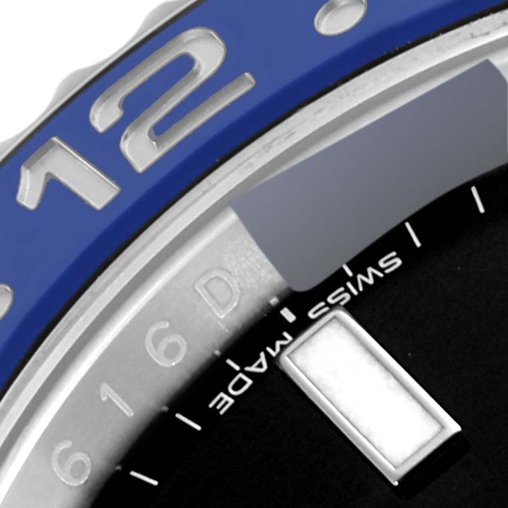 This close-up angle of the Rolex GMT-Master 116710 Men
s Stainless Steel Black Dial 116710 Men
s Stainless Steel Black Dial shows part of the blue bezel, the 
12
 marker, and a section of the dial with "Swiss Made" text.