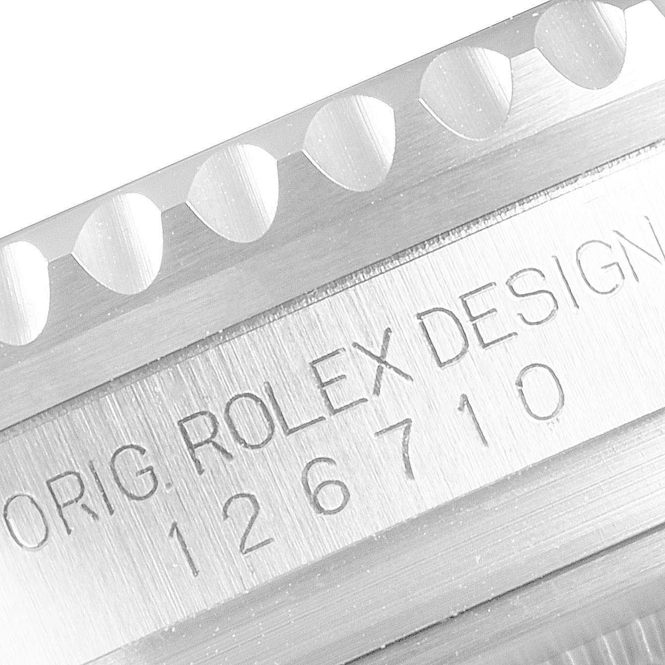 This image shows a close-up of the engraved case and bezel teeth of the Rolex GMT-Master 126710 Men
s Stainless Steel Black Dial 126710 Men
s Stainless Steel Black Dial model.