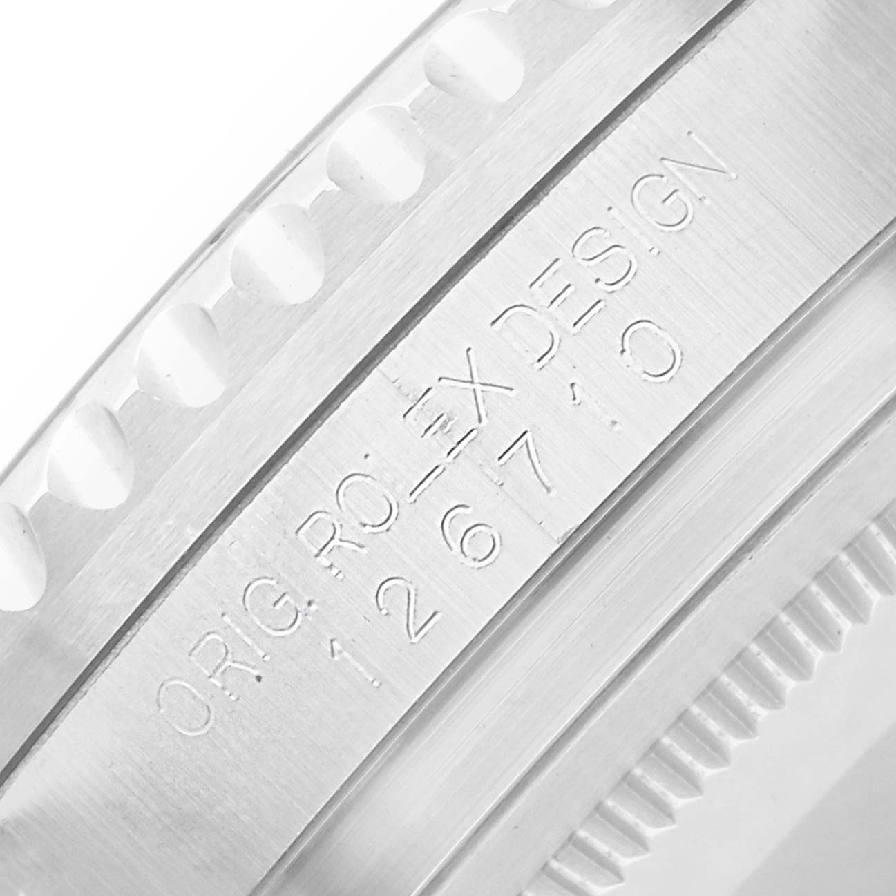 The image shows a close-up of the Rolex GMT-Master 126710 Men
s Stainless Steel Black Dial
s case side, featuring engravings and edge detailing.