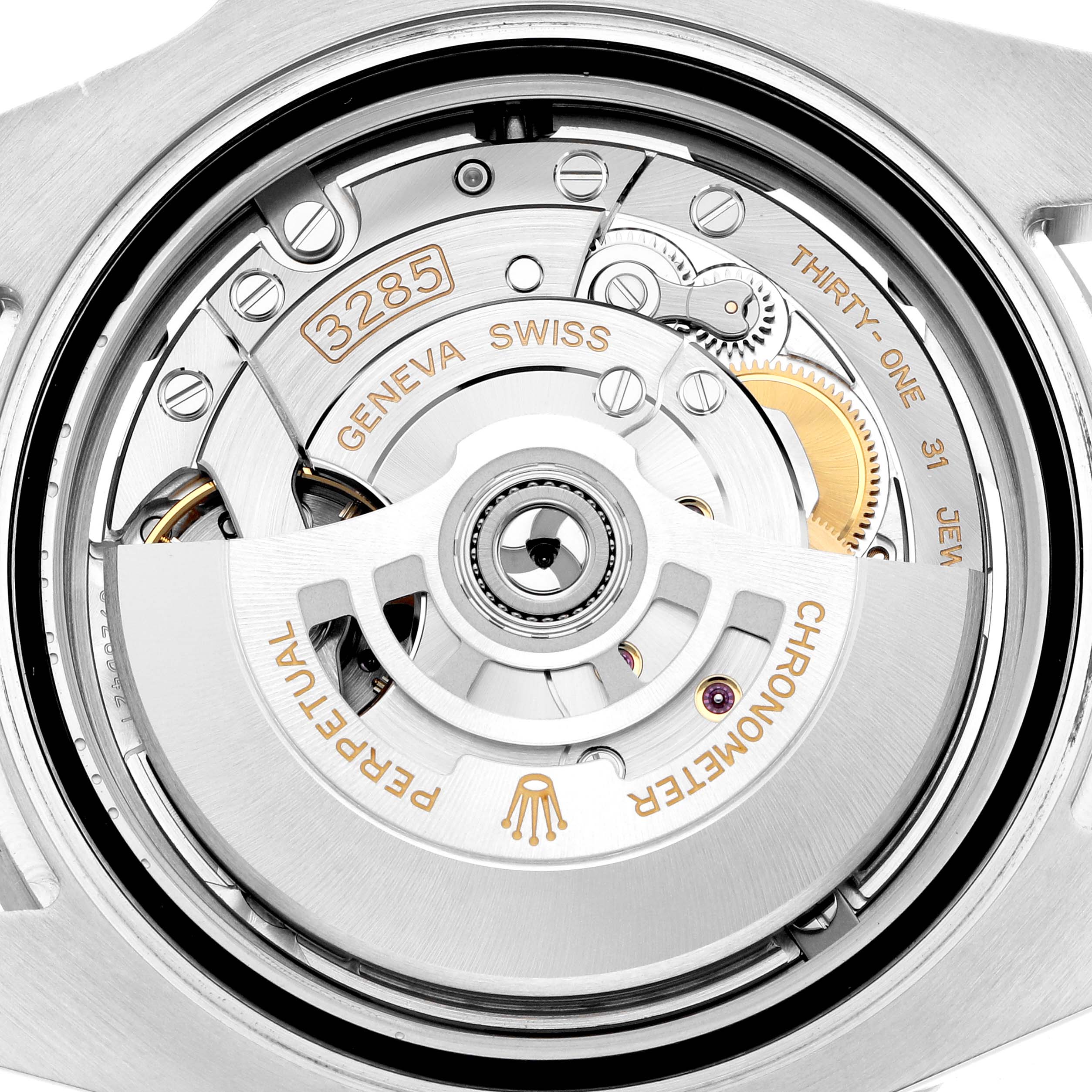 The image shows a close-up view of the movement mechanism of the Rolex GMT-Master 126710 Men
s Stainless Steel Black Dial, highlighting details like the rotor and gears.