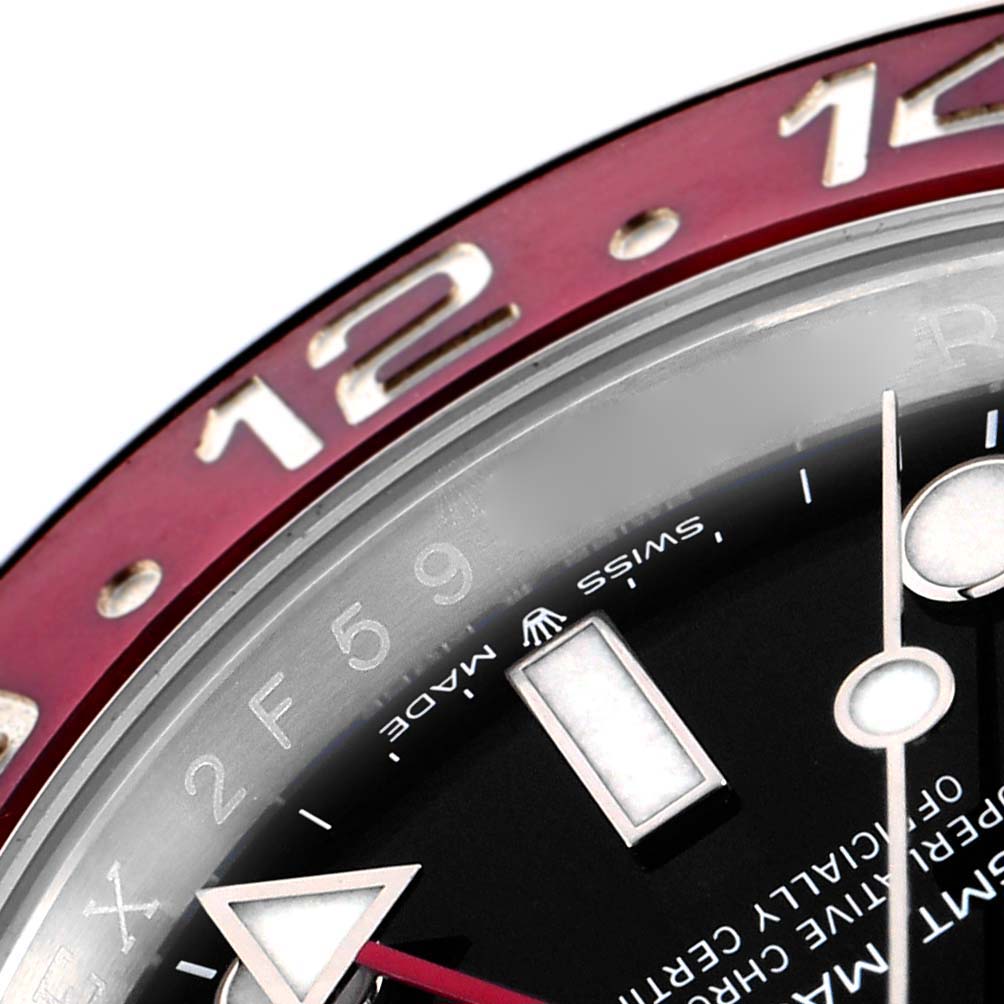 The image shows a close-up of the Rolex GMT-Master 126710 Men
s Stainless Steel Black Dial watch, highlighting the bezel, part of the dial, and hour markers.