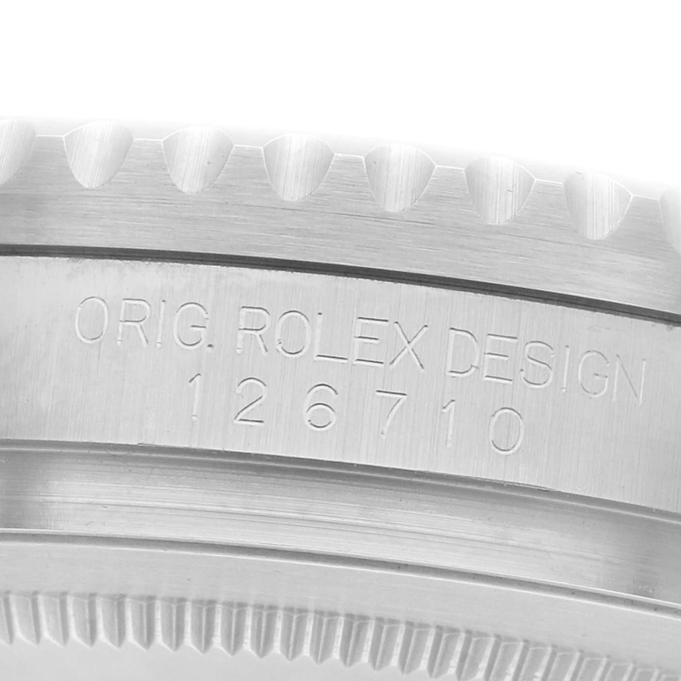 The image shows the side profile of a Rolex GMT-Master 126710 Men
s Stainless Steel Black Dial model, focusing on the engraved case side and bezel teeth.