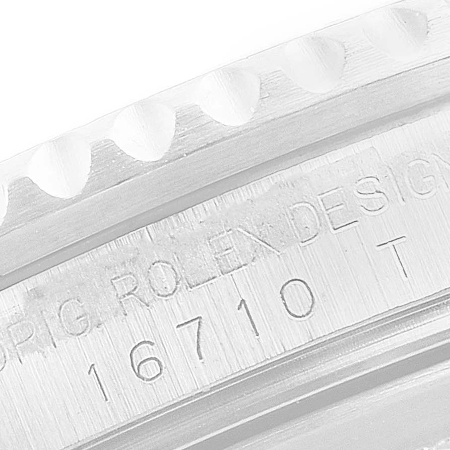 This close-up image of the Rolex GMT-Master 16710 Men
s Stainless Steel Black Dial 16710 Men
s Stainless Steel Black Dial watch shows part of the bezel edge and the engraved model number "16710 T."