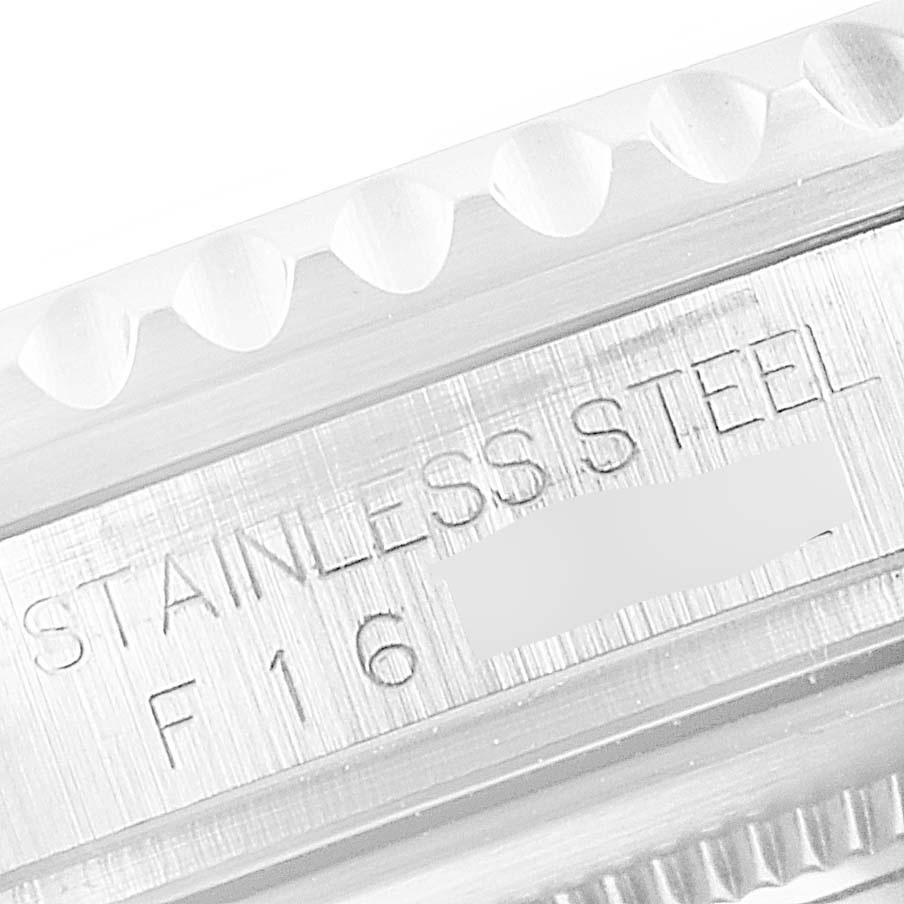 This image shows a close-up of the side of a Rolex GMT-Master 16710 Men
s Stainless Steel Black Dial 16710 Men
s Stainless Steel Black Dial watch case with the "STAINLESS STEEL" engraving.