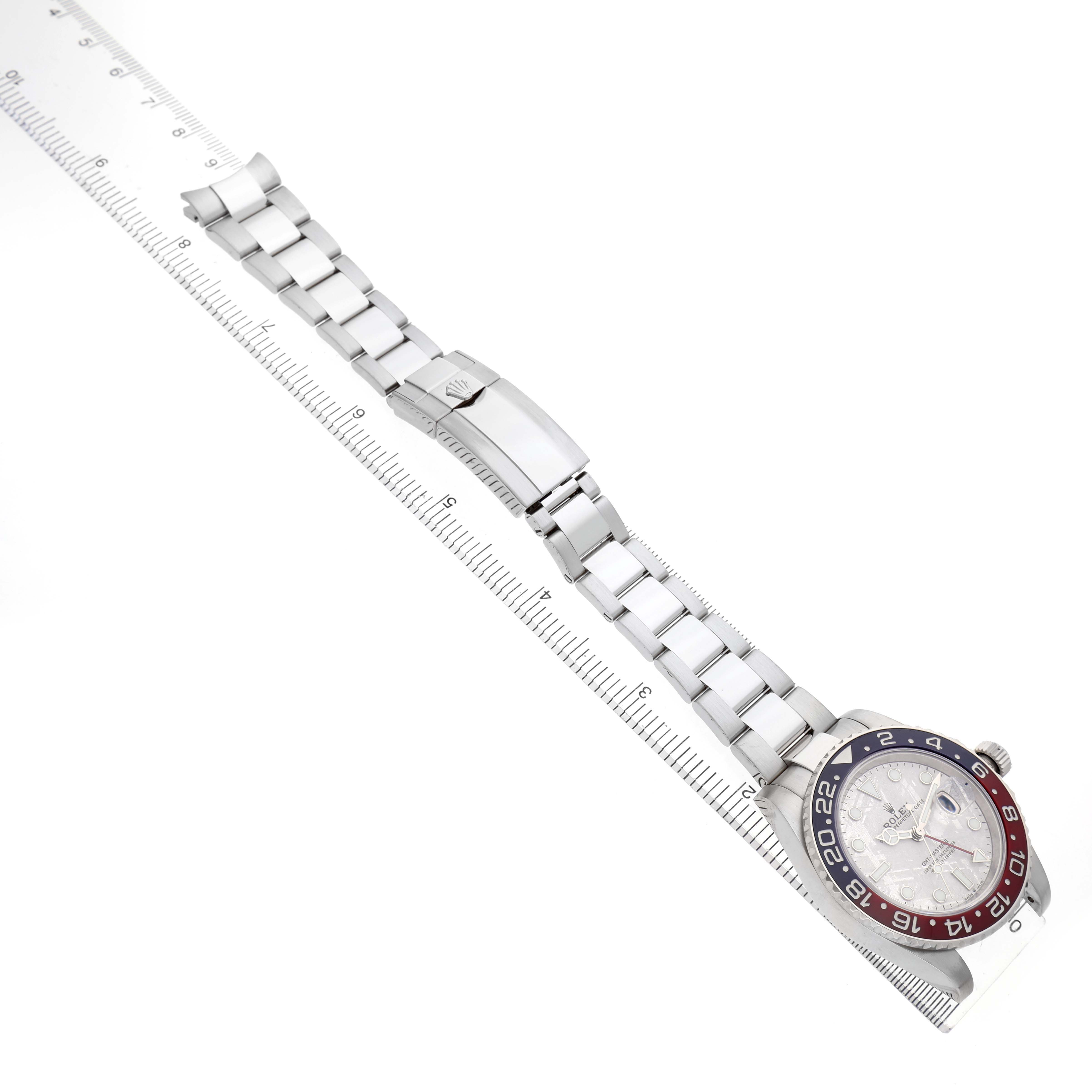 The Rolex GMT-Master 126719BLRO Men's White Gold Silver Dial watch is shown from a top-down angle, highlighting the bezel, dial, and full bracelet with a clasp.
