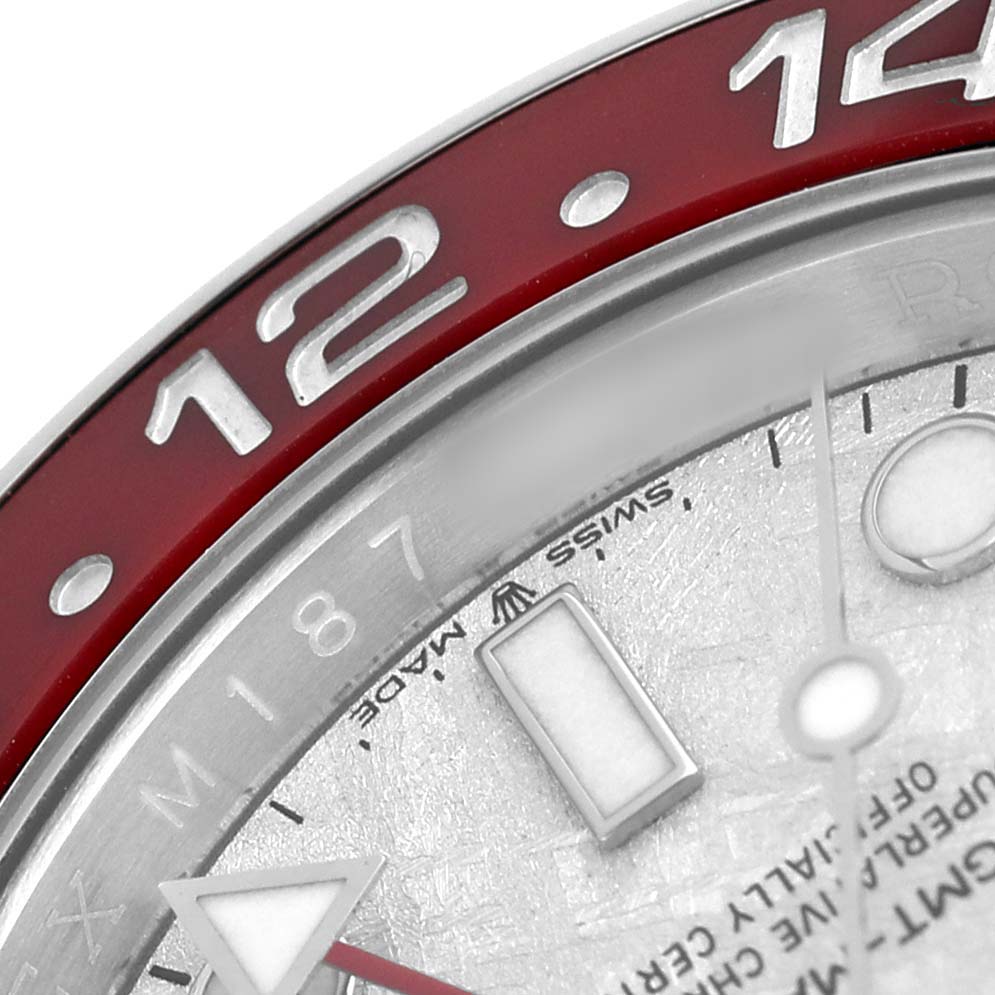 The image shows a close-up of the Rolex GMT-Master 126719BLRO Men's White Gold Silver Dial's bezel, dial, and part of the watch hand.