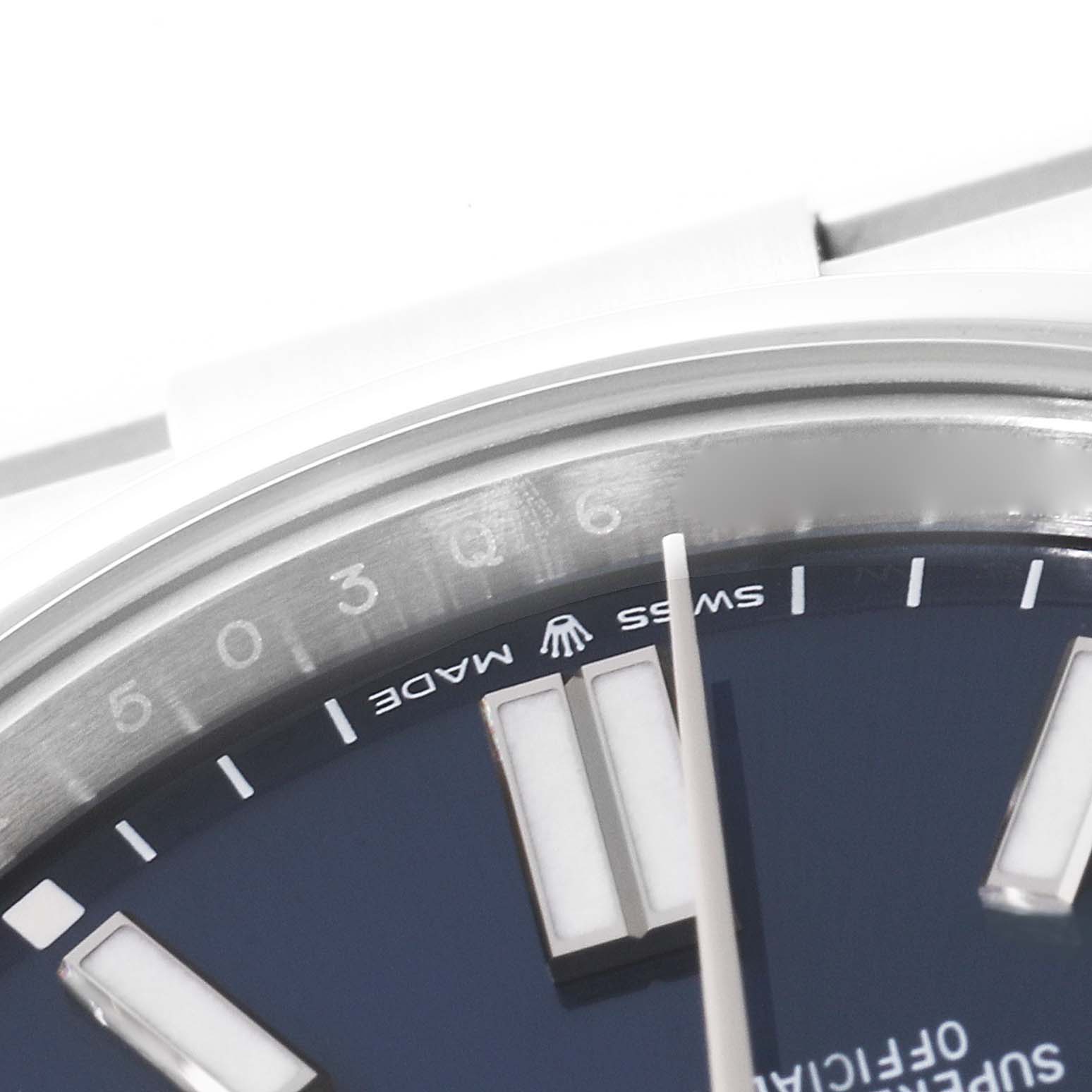 The image shows a close-up of the dial and bezel part of a Rolex Oyster Perpetual 124300 Men's Stainless Steel Blue Dial 124300 Men's Stainless Steel Blue Dial watch, focusing on the "Swiss Made" text and hour markers.
