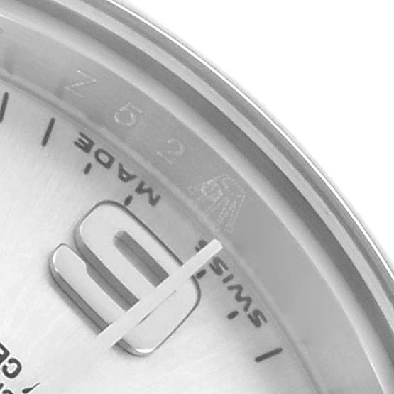The image shows a close-up of a Rolex Datejust 176200 Women's Stainless Steel Silver Dial watch dial, focusing on the "6" marker, minute track, and part of the text "Swiss Made."