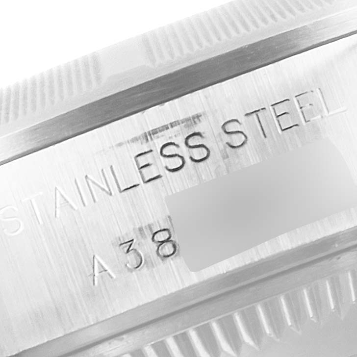 This is a close-up of the Rolex Date 69190 Women's Stainless Steel Pink Dial 69190 Women's Stainless Steel Pink Dial model, focusing on the engraved "STAINLESS STEEL" and partial serial number on the watch case.