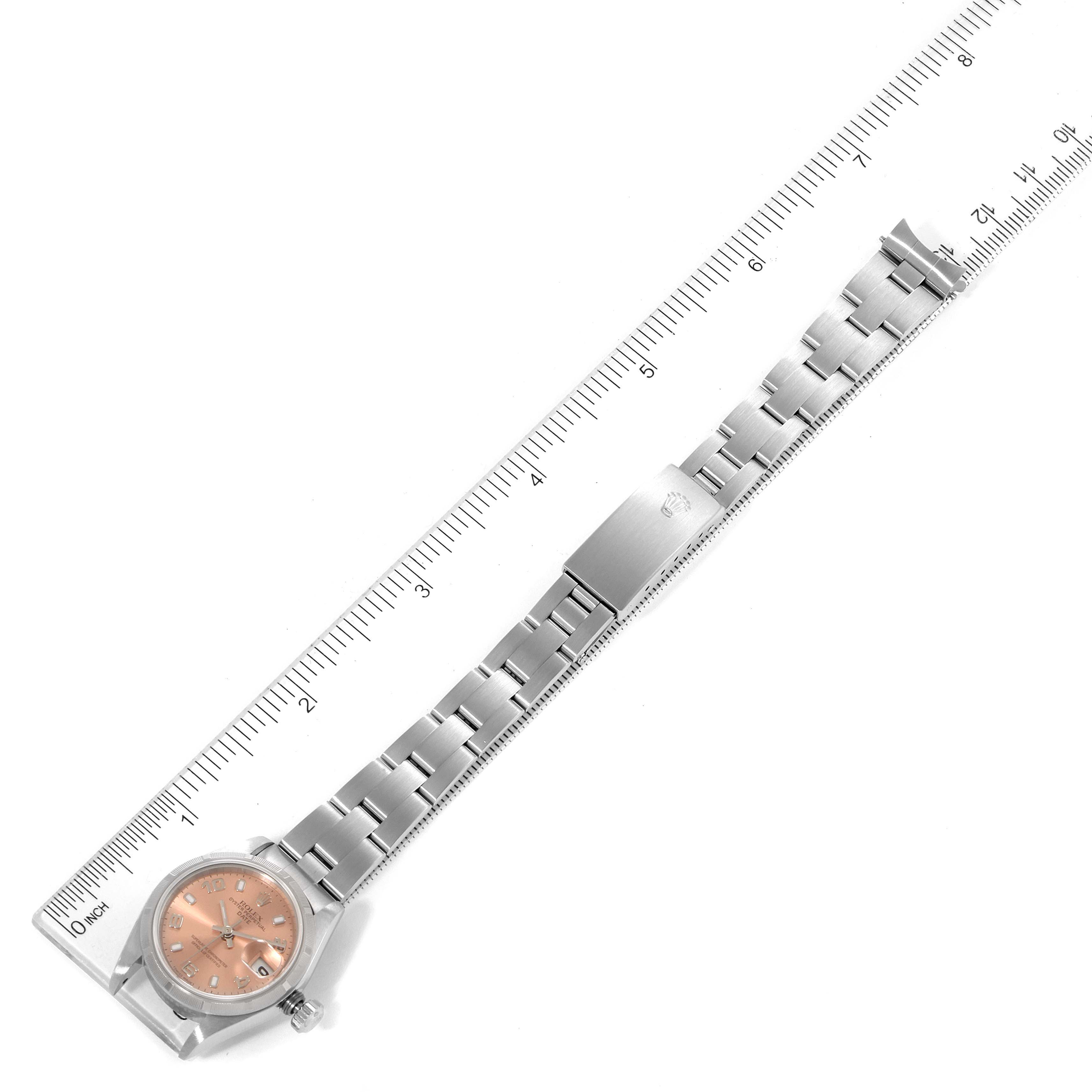 The image shows a top-down view of a Rolex Date 69190 Women's Stainless Steel Pink Dial 69190 Women's Stainless Steel Pink Dial model watch with a metal bracelet measured against a ruler.