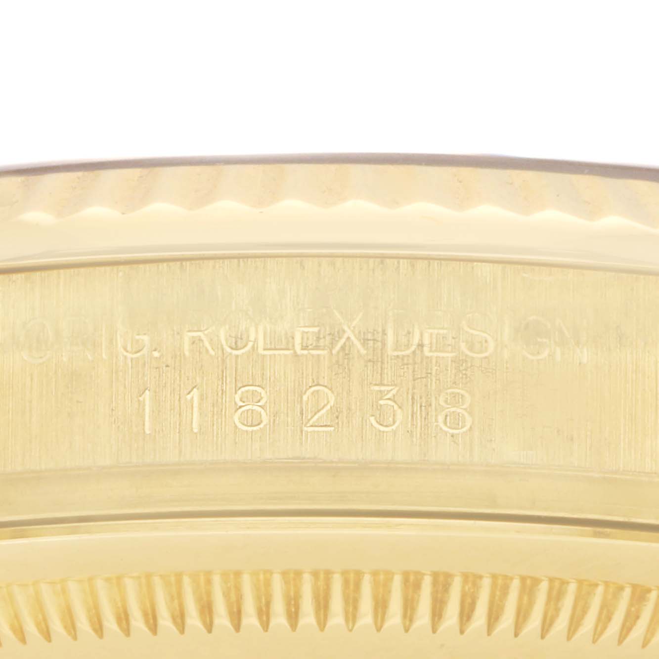 The image shows the side view of the Rolex President 118238 Men
s Yellow Gold Champagne Dial model
s bezel and engraved case with the design details.