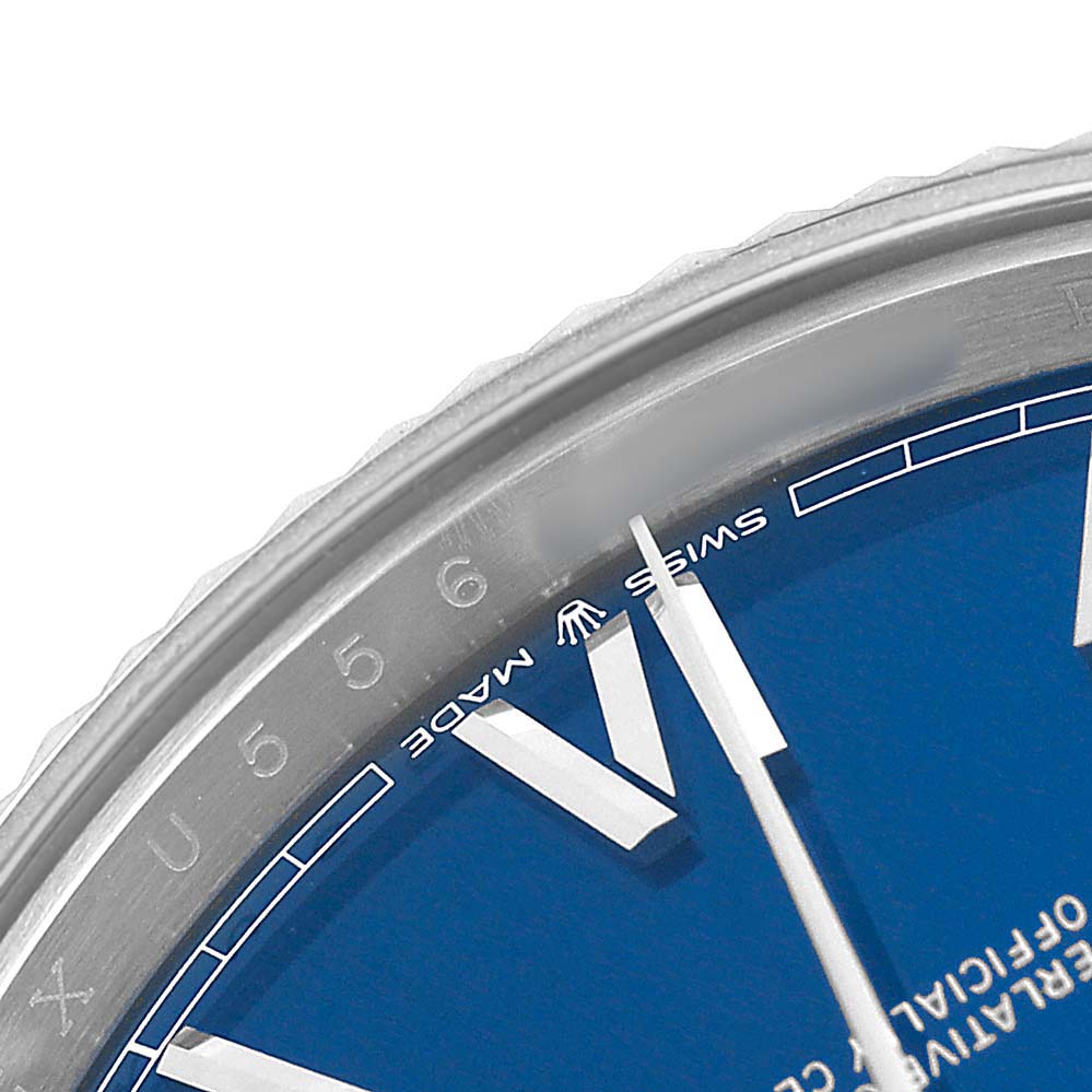The image shows a close-up of the dial and bezel of the Rolex President 228239 Men's White Gold Blue Dial watch, focusing on the hour markers and part of the blue face.