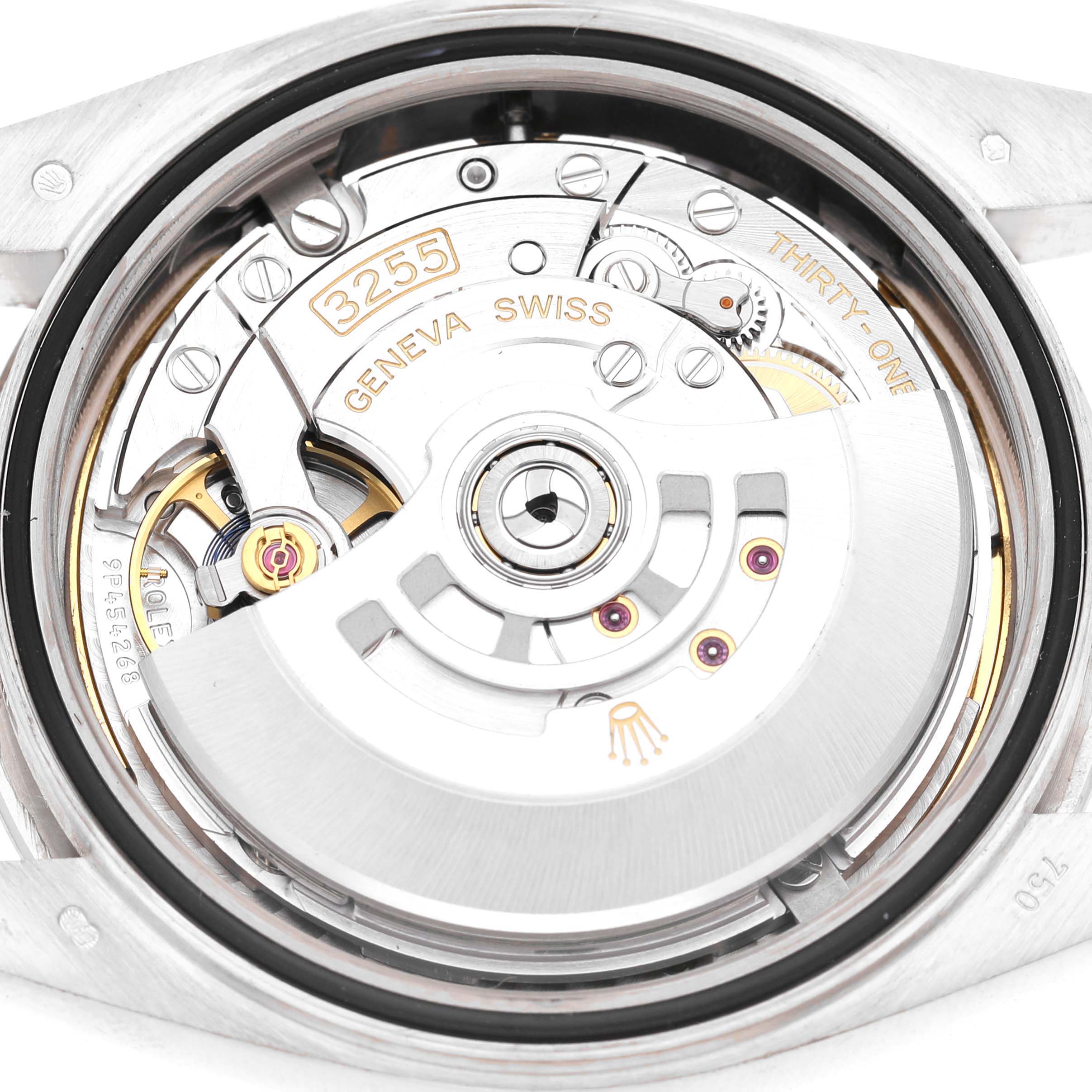 The image shows the movement of a Rolex President 228239 Men's White Gold Blue Dial model from the back, highlighting the intricate mechanism and rotor.