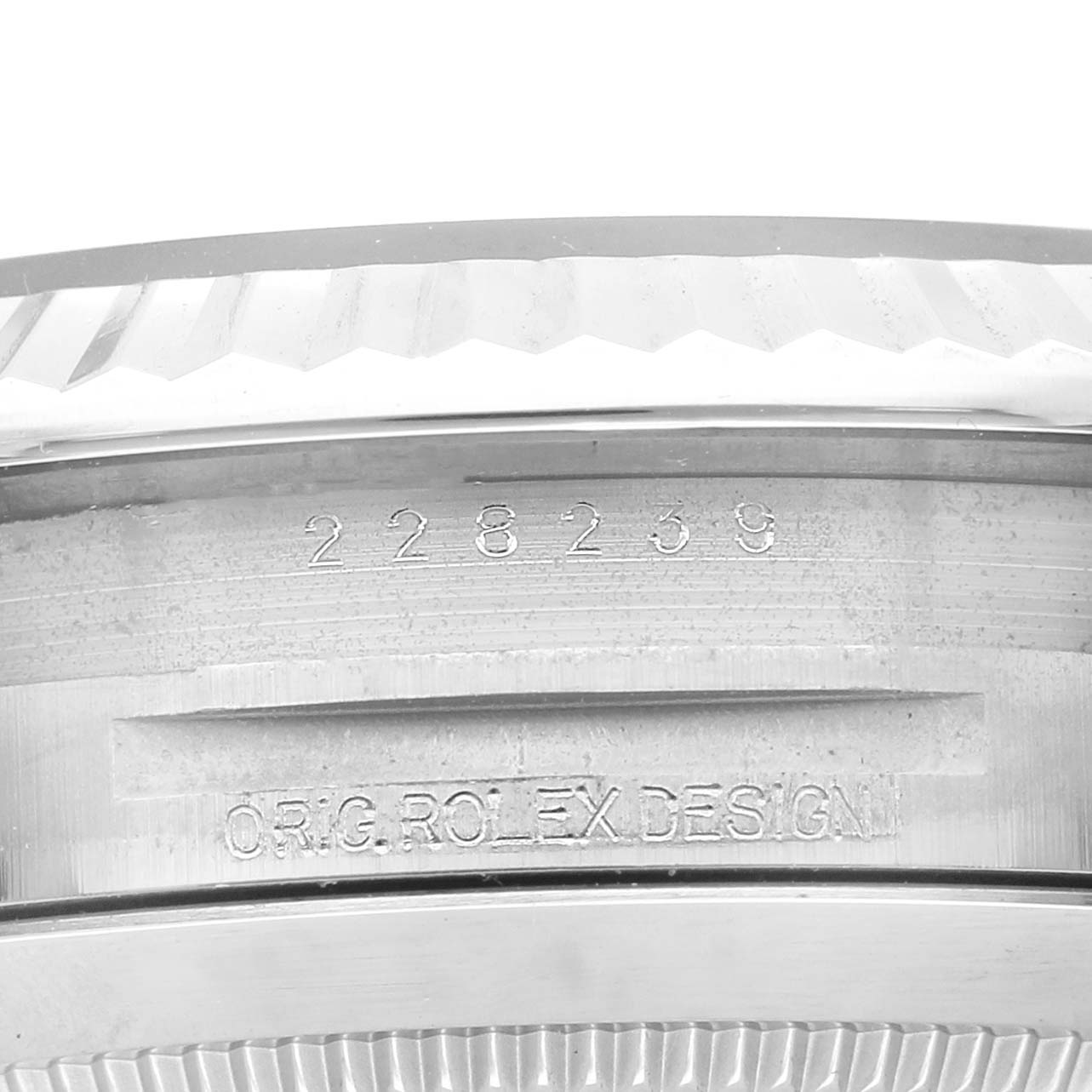 The image shows a close-up of the serial number engraving on a Rolex President 228239 Men's White Gold Blue Dial model watch case.