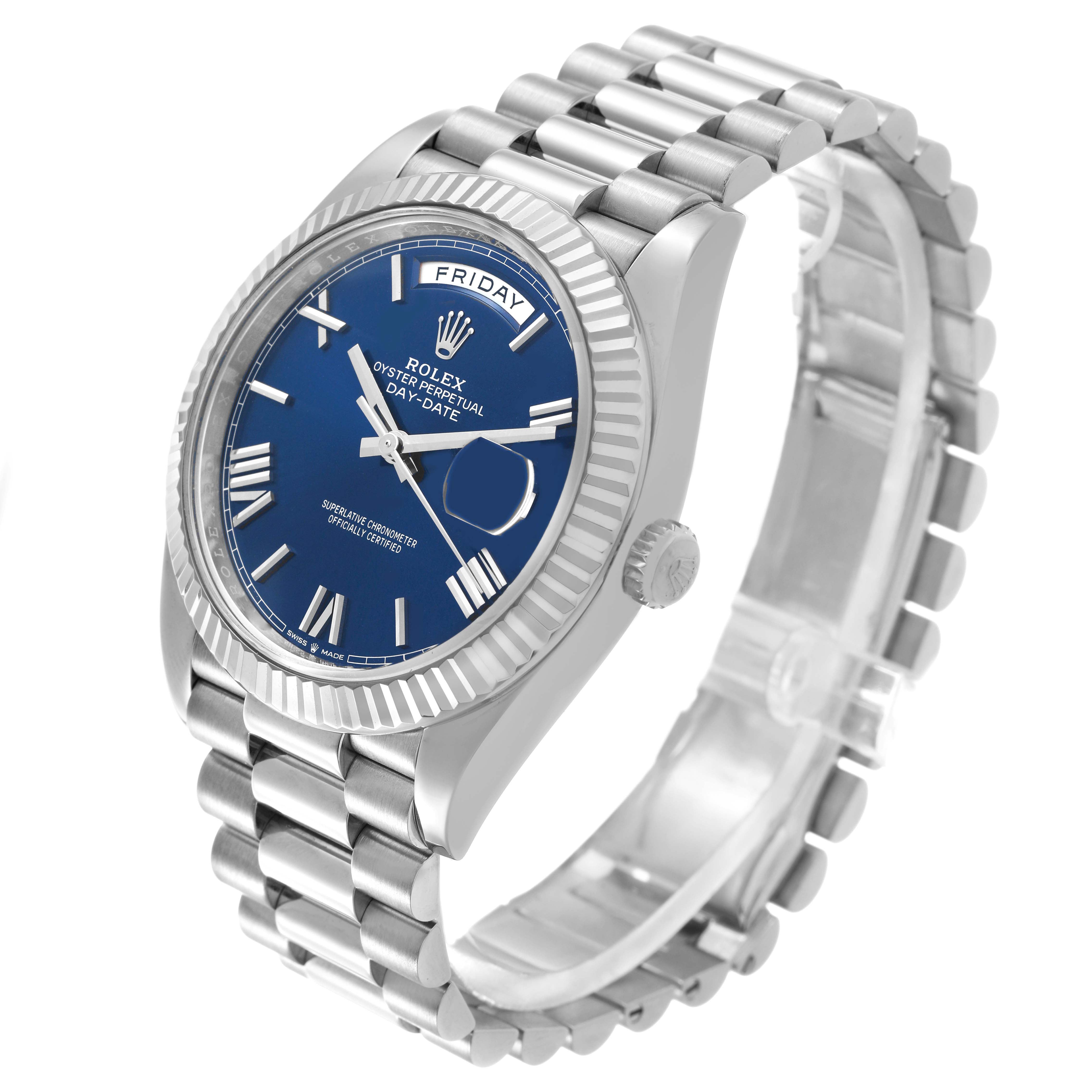 The Rolex President 228239 Men's White Gold Blue Dial model is shown from an angled side view, highlighting the blue dial, fluted bezel, and linked bracelet.
