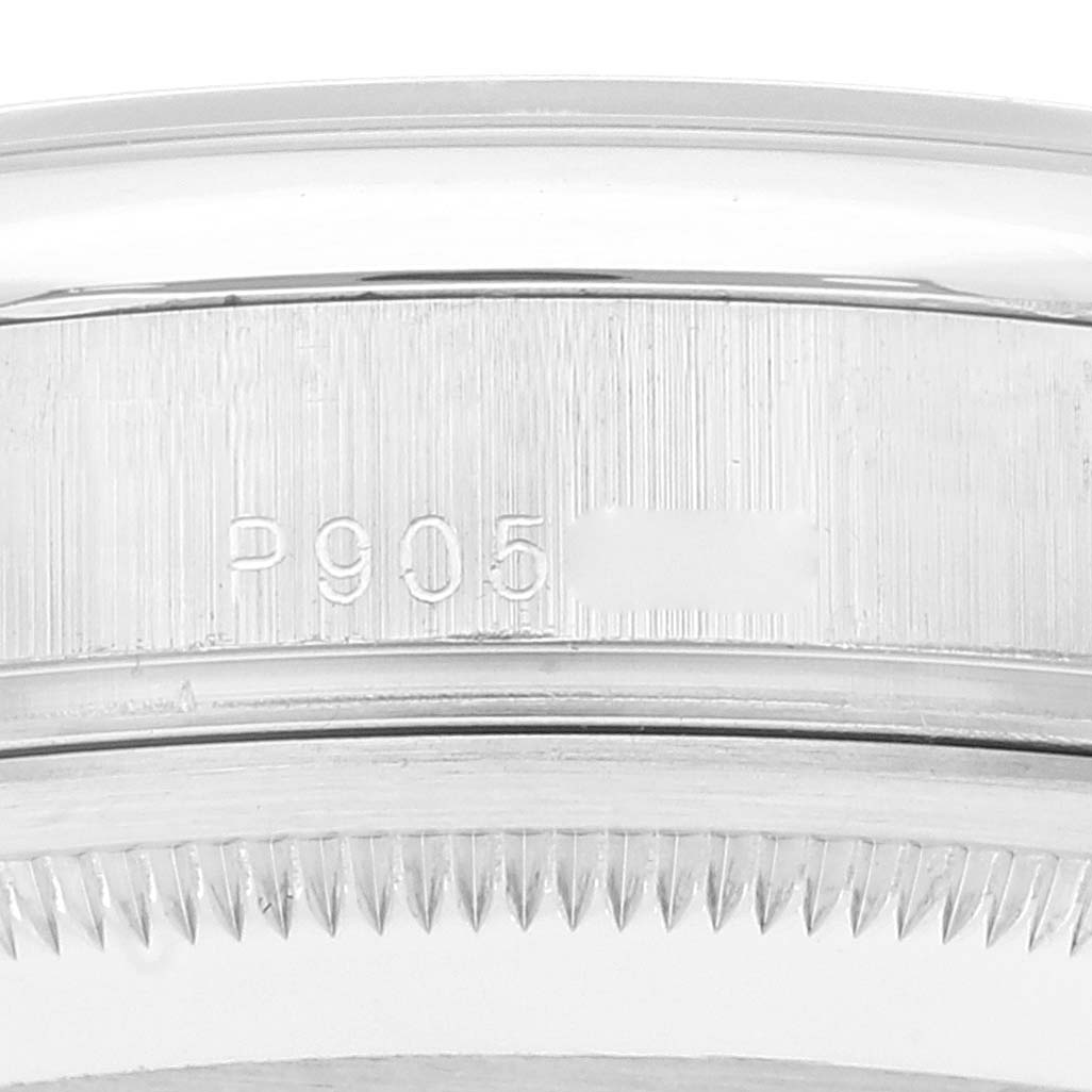 This close-up image shows the side view of the case and bezel of the Rolex President 118206 Men's Platinum Blue Dial 118206 Men's Platinum Blue Dial model watch with the engraved serial number.