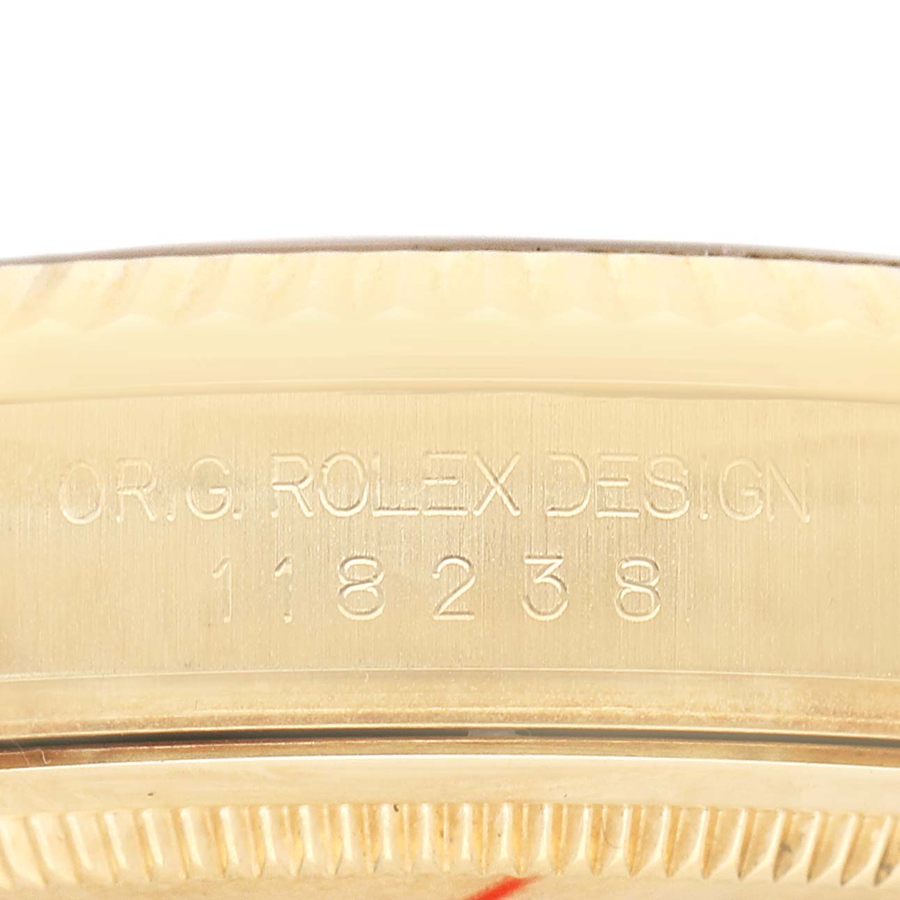 The image shows a close-up of the engraving on the side of the Rolex President 118238 Men's Yellow Gold Champagne Dial watch case with model number 118238.
