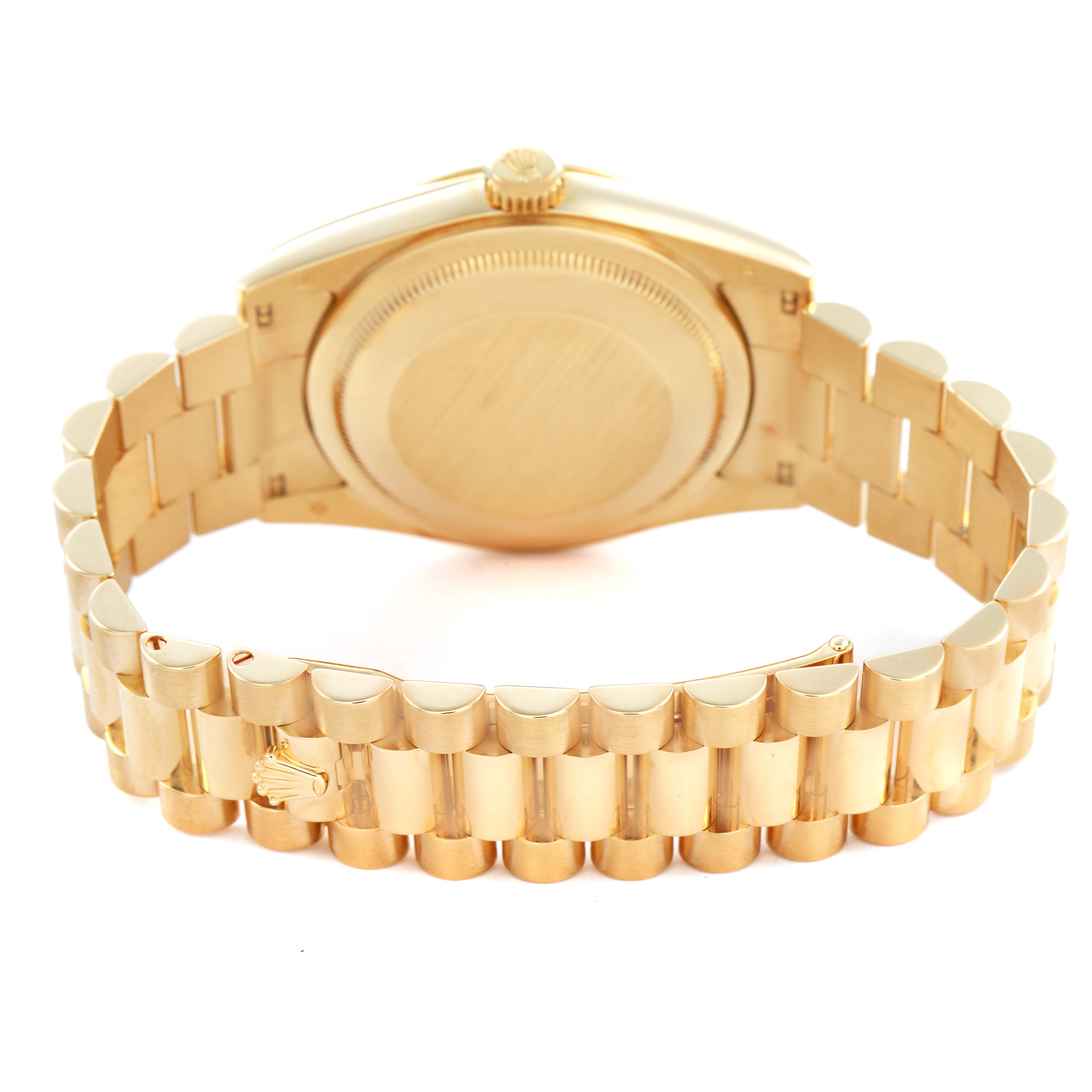 The Rolex President 118238 Men's Yellow Gold Champagne Dial model watch is shown from the back, highlighting the case back and the gold bracelet with the clasp partially visible.