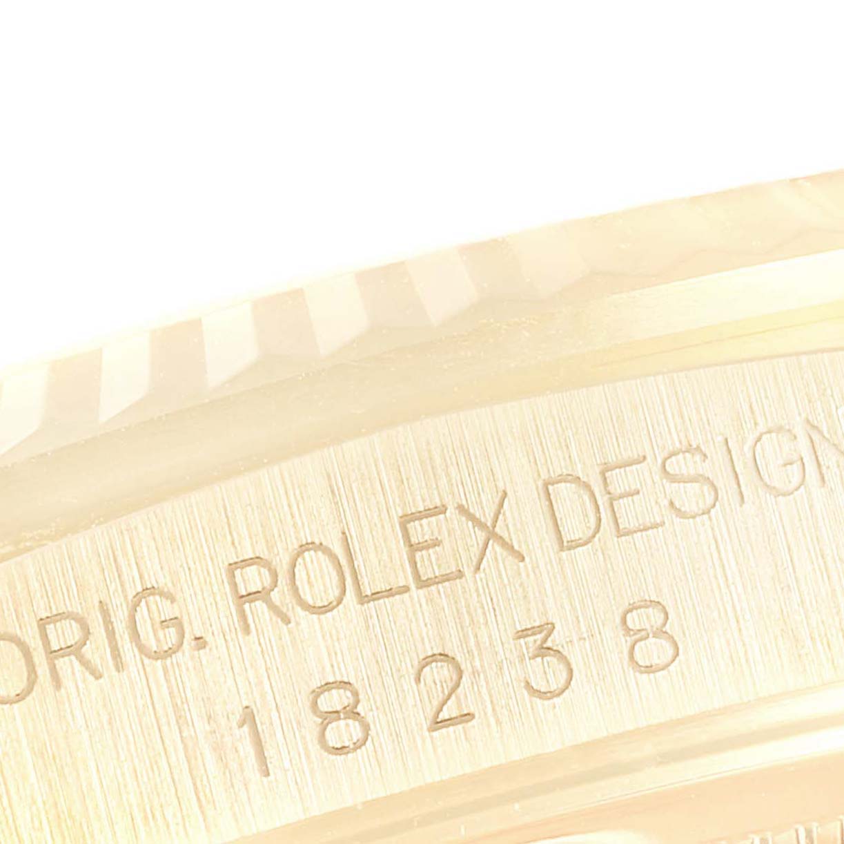 The image shows a close-up of the side of the bezel and case engraved with "Orig. Rolex Design" and the model number of the Rolex President 18238 Men
s Yellow Gold Champagne Dial 18238 Men
s Yellow Gold Champagne Dial watch.