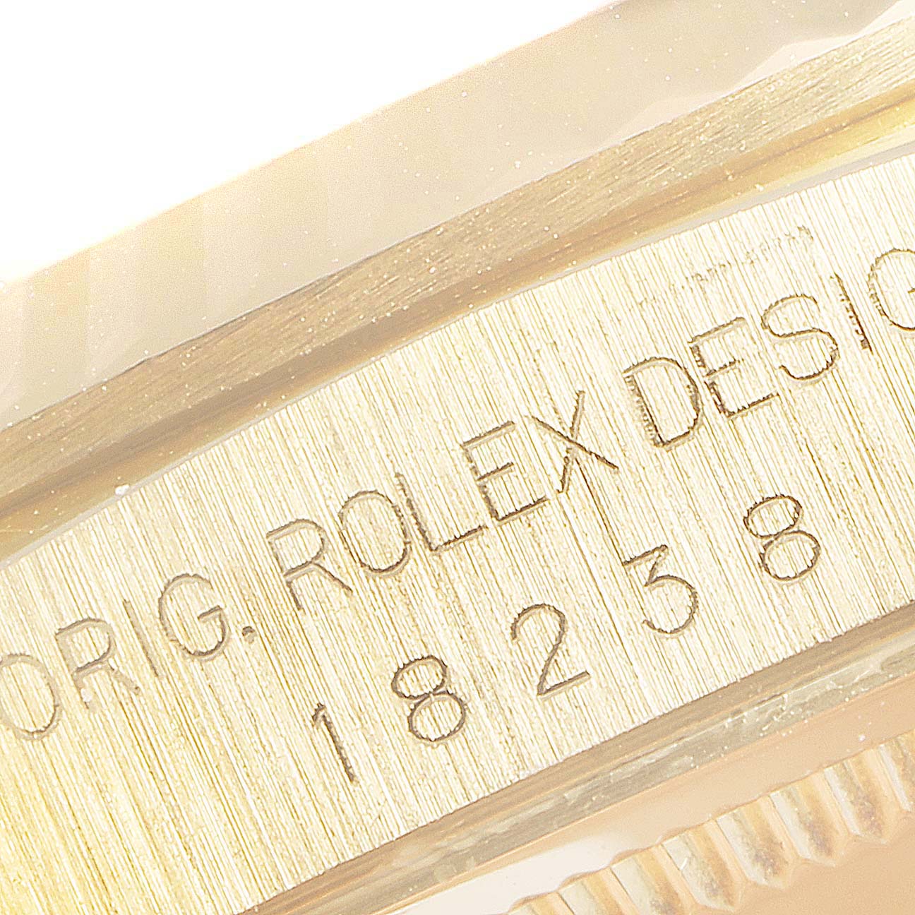 The image shows a close-up of the engraved bezel of the Rolex President 18238 Men's Yellow Gold Champagne Dial 18238 Men's Yellow Gold Champagne Dial watch model 18238.