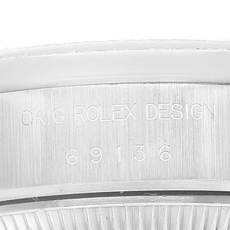 The image shows a close-up of the engraved reference number on the side of a Rolex President 69136 Women's Stainless Steel Silver Dial 69136 Women's Stainless Steel Silver Dial model watch case.