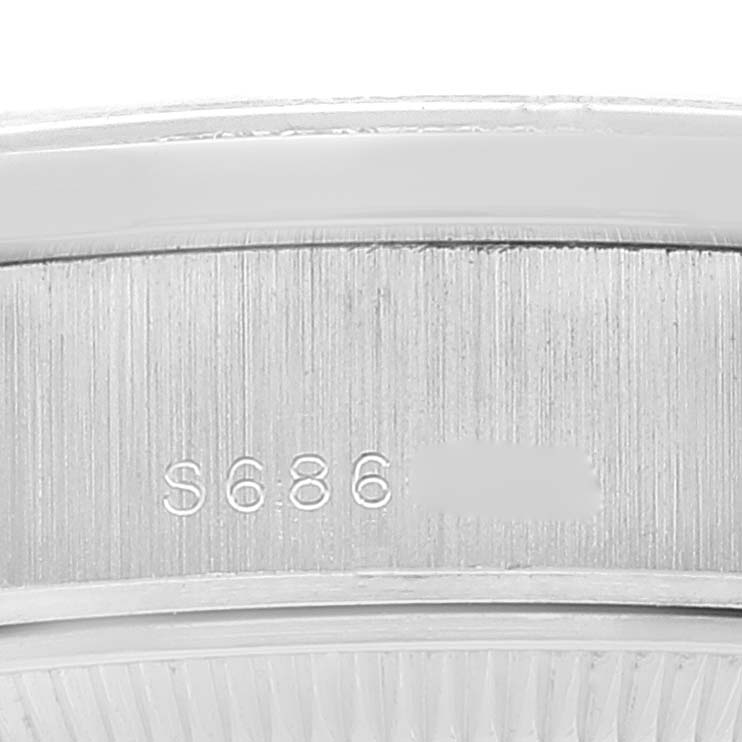 The image shows a close-up of the engraved serial number on the side of the Rolex President 69136 Women's Stainless Steel Silver Dial 69136 Women's Stainless Steel Silver Dial model watch.