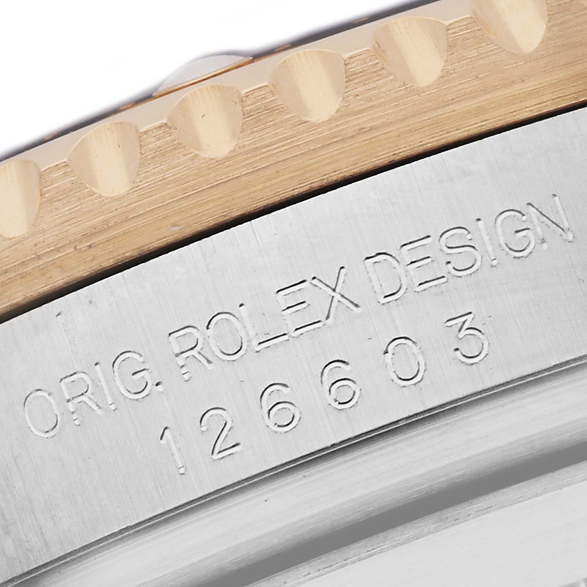 The image shows a close-up of the side of a Rolex Sea-Dweller 126603 Men
s Steel and Gold (two tone) Black Dial, highlighting the engraved model number and bezel.