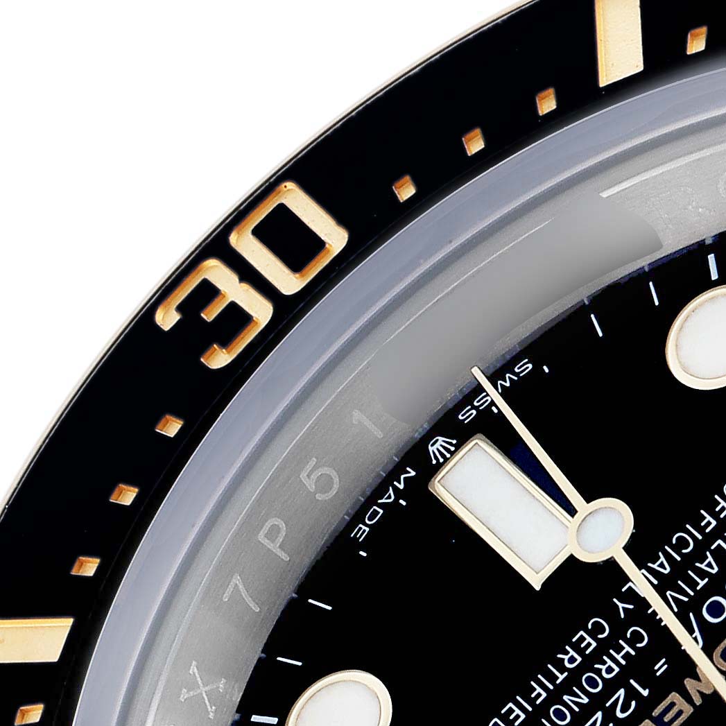 The image shows a close-up of the bezel and partial dial of the Rolex Sea-Dweller 126603 Men
s Steel and Gold (two tone) Black Dial, highlighting the "30" marker and hour hand.