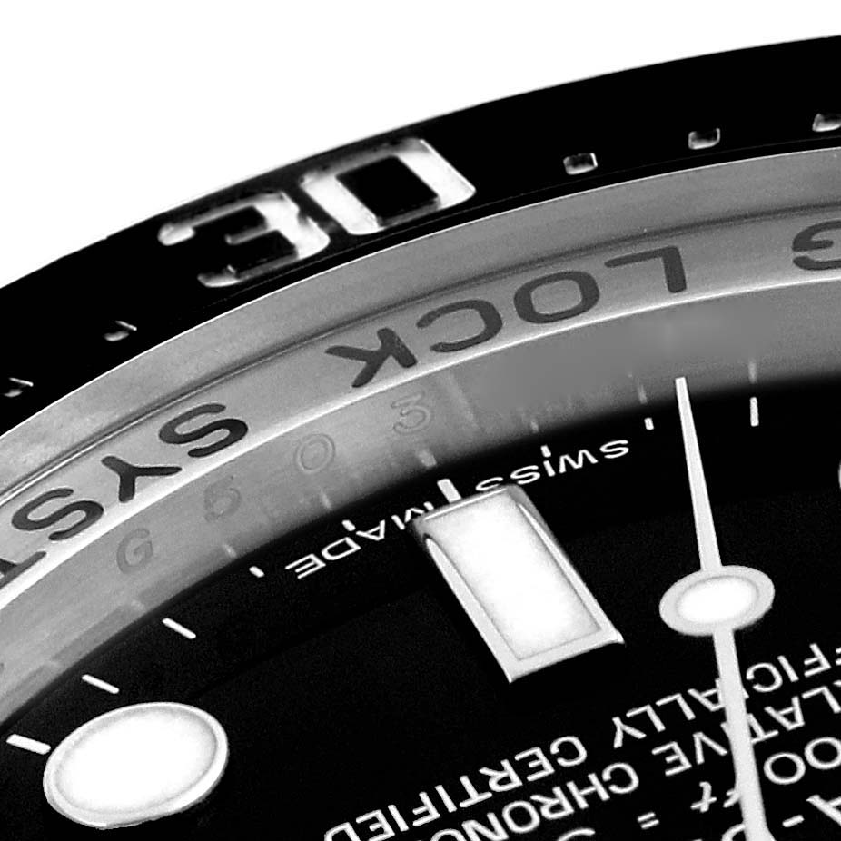 The image shows a close-up of the Rolex Sea-Dweller 116660 Men
s Stainless Steel Black Dial 116660 Men
s Stainless Steel Black Dial model
s dial, specifically highlighting the bezel and part of the minute hand.