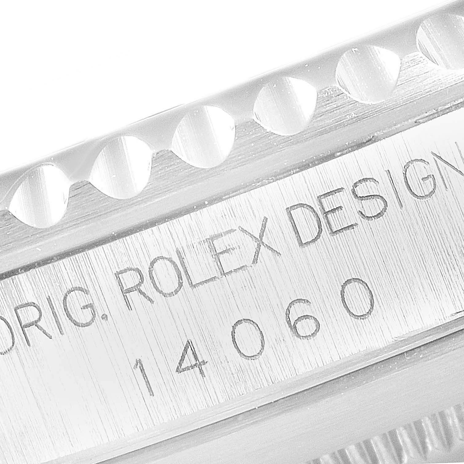 The image shows a close-up of the engraving on the side case of a Rolex Submariner 14060 Men
s Stainless Steel Black Dial 14060 Men
s Stainless Steel Black Dial model, featuring the design and model number.