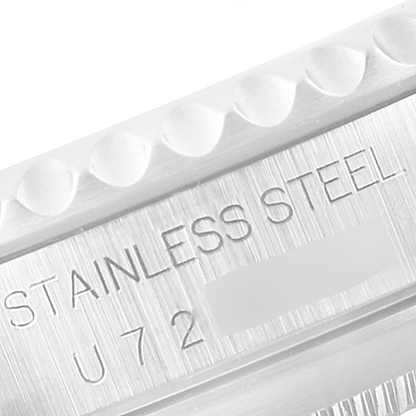 This close-up image shows the stainless steel inscription and part of the bezel of a Rolex Submariner 14060 Men
s Stainless Steel Black Dial 14060 Men
s Stainless Steel Black Dial watch.