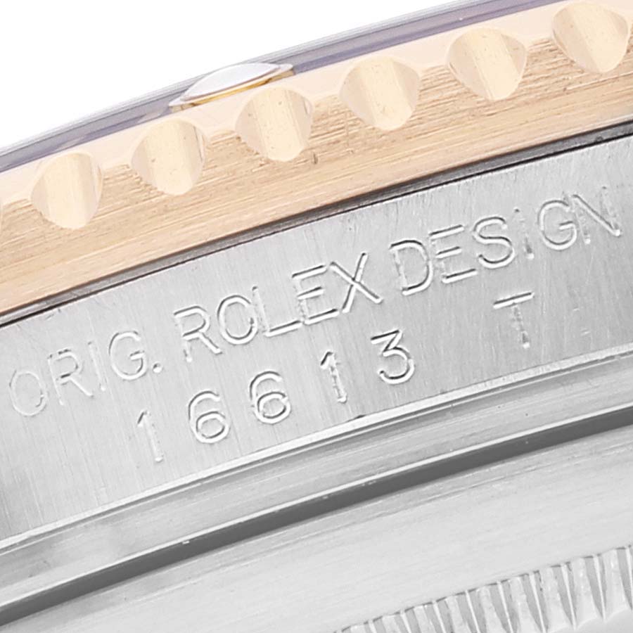 The image shows a close-up of the case back edge of a Rolex Submariner 16613 Men's Steel and Gold (two tone) Blue Dial 16613 Men's Steel and Gold (two tone) Blue Dial, highlighting the engraved text and part of the bezel.
