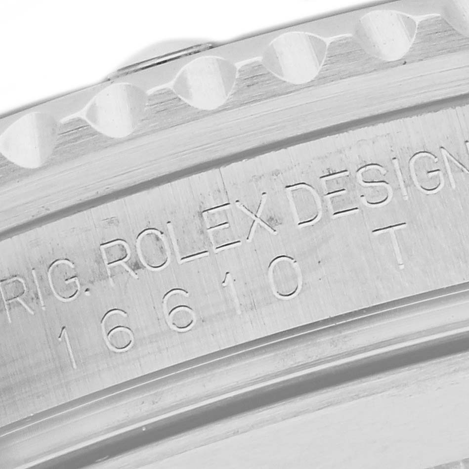 The image shows a close-up of the side of a Rolex Submariner 16610 Men
s Stainless Steel Black Dial 16610 Men
s Stainless Steel Black Dial, highlighting its bezel and engraved model number.