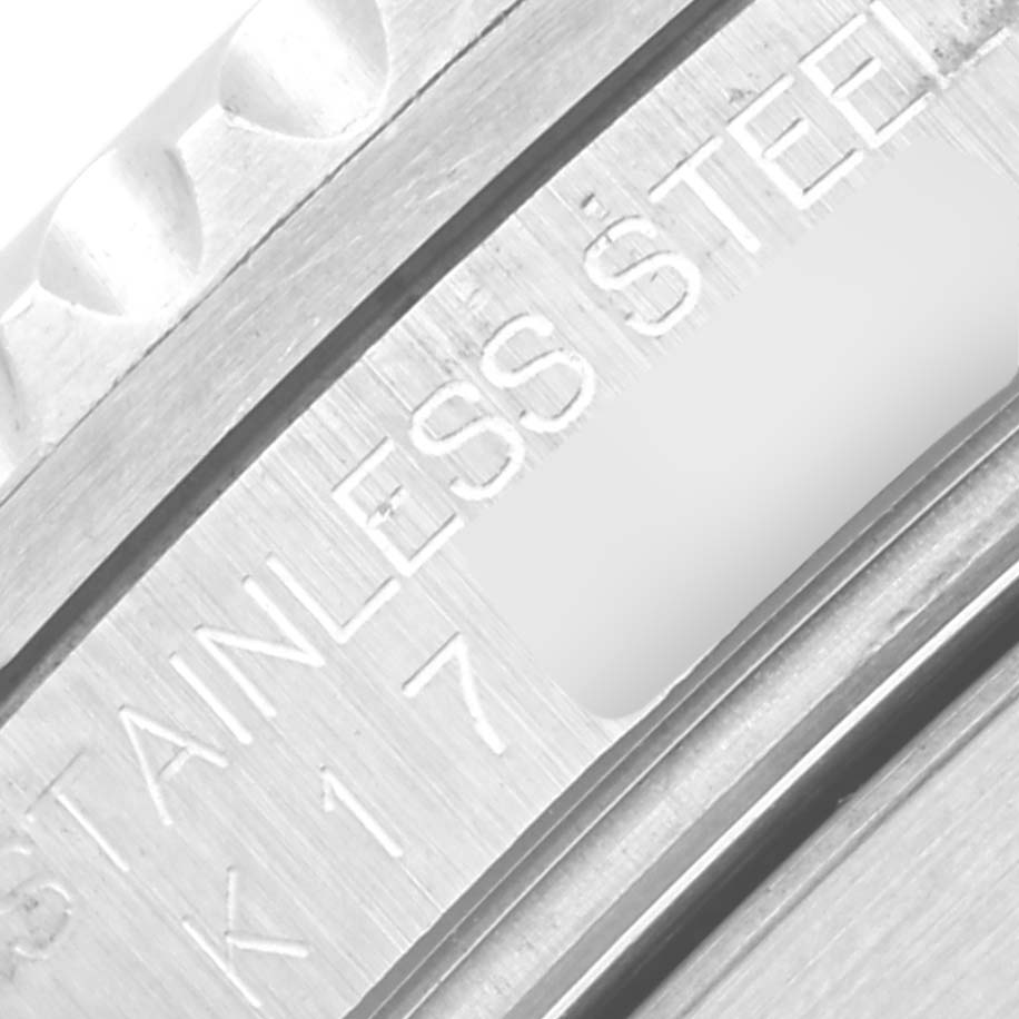 This image shows a close-up of the engraved text "STAINLESS STEEL" on the case of a Rolex Submariner 16610 Men
s Stainless Steel Black Dial 16610 Men
s Stainless Steel Black Dial watch.