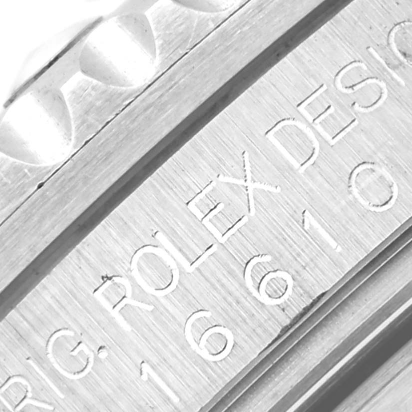 The image shows a close-up angle of the model and serial number engraved on the case of a Rolex Submariner 16610 Men
s Stainless Steel Black Dial 16610 Men
s Stainless Steel Black Dial.