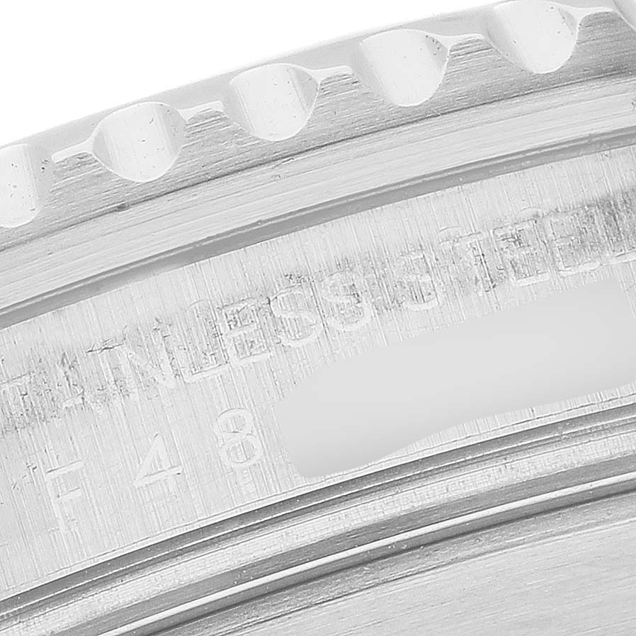 The image shows a close-up of the bezel and edge details, along with the engraved text on the case of a Rolex Submariner 16610 Men's Stainless Steel Black Dial.