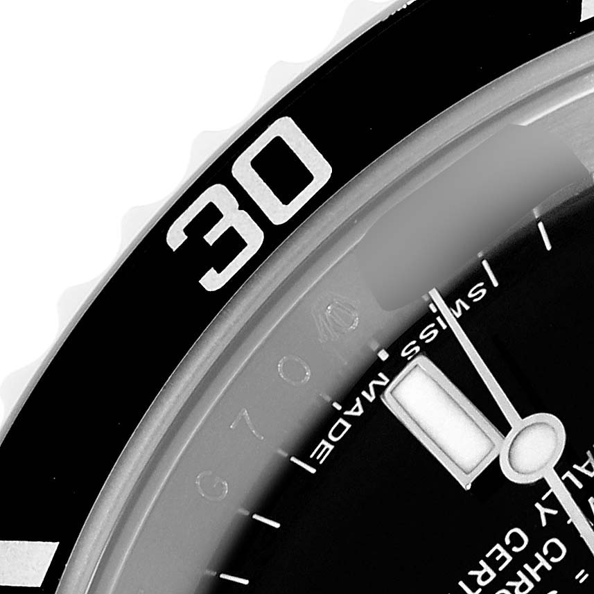 The image shows a close-up of the bezel and part of the dial of the Rolex Submariner 14060M Men
s Stainless Steel Black Dial, highlighting the 30-minute marker.