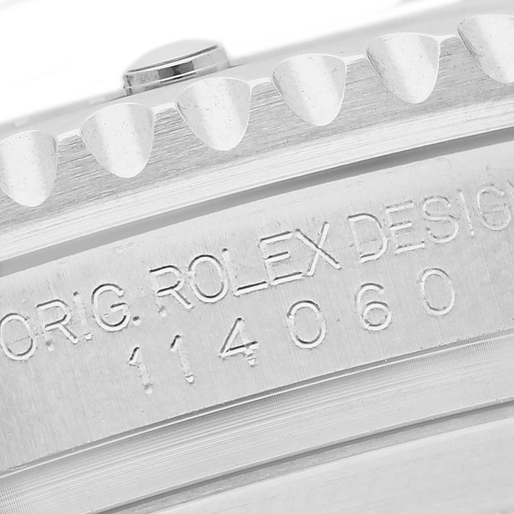 The image shows a close-up of the engraved side view of a Rolex Submariner 114060 Men's Stainless Steel Black Dial, highlighting the model details.