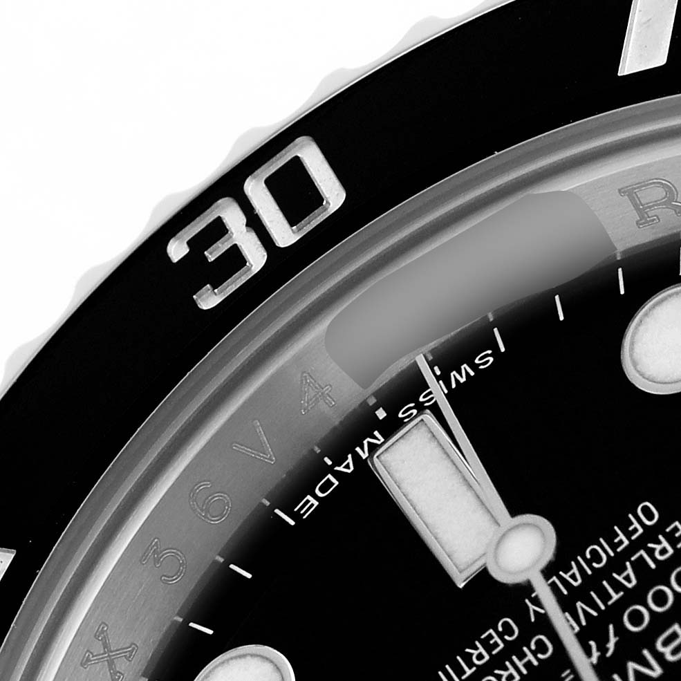 The image shows a close-up of the Rolex Submariner 114060 Men's Stainless Steel Black Dial's bezel at the 30-minute mark, along with part of the dial and "SWISS MADE" text.