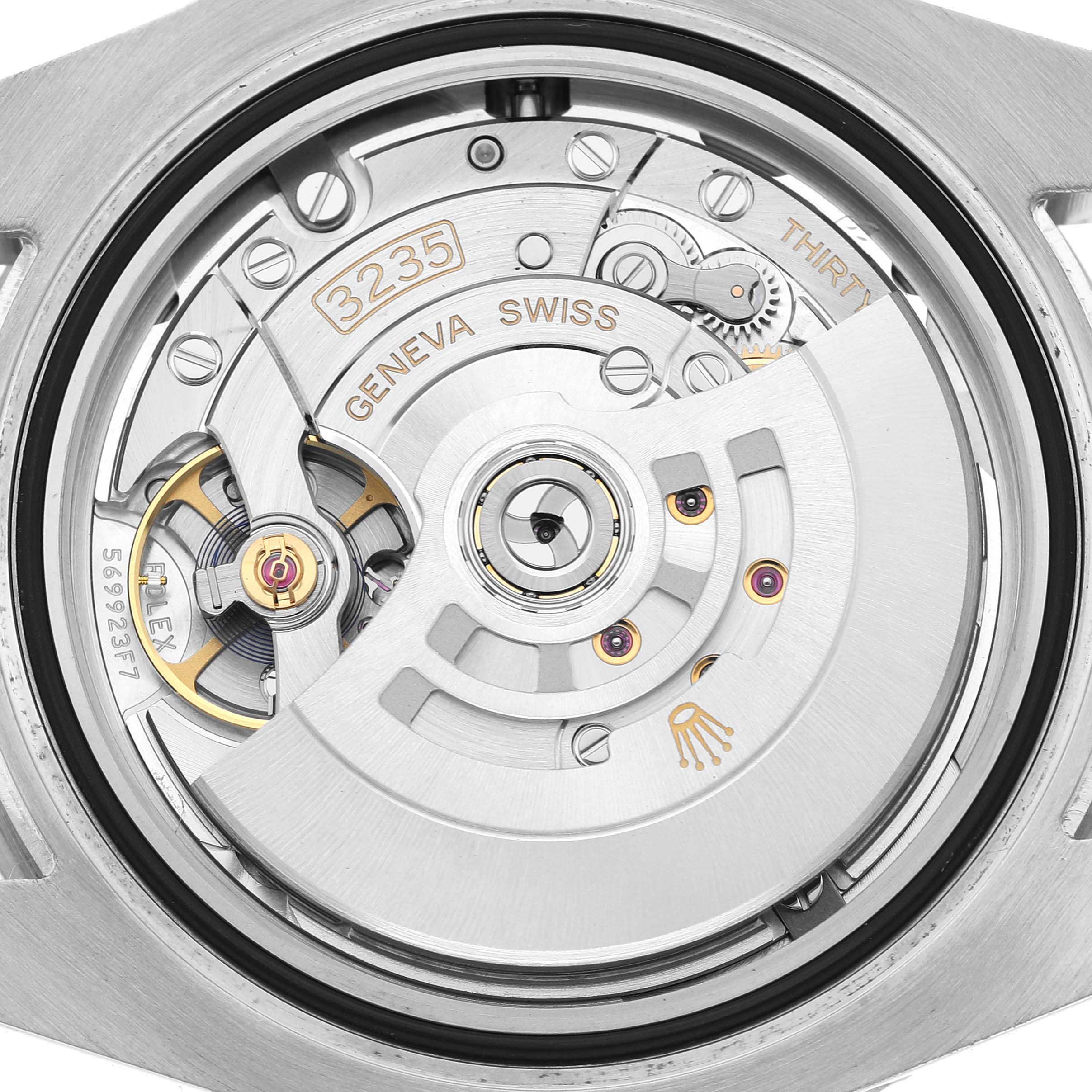 The image shows the back view of a Rolex Submariner 126610LV Men's Stainless Steel Black Dial, focusing on its intricate automatic movement.