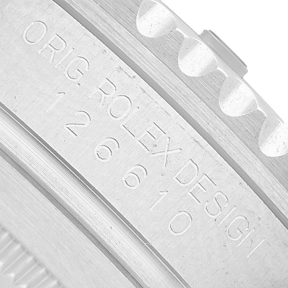 The image shows a close-up of the engraved side of the Rolex Submariner 126610LV Men's Stainless Steel Black Dial bezel with text details.