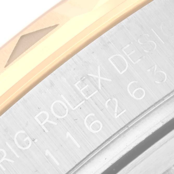 This is a close-up view of the edge and engraved text on the bezel of the Rolex Turn-o-Graph 116263 Men
s Steel and Gold (two tone) White Dial 116263 Men
s Steel and Gold (two tone) White Dial watch.