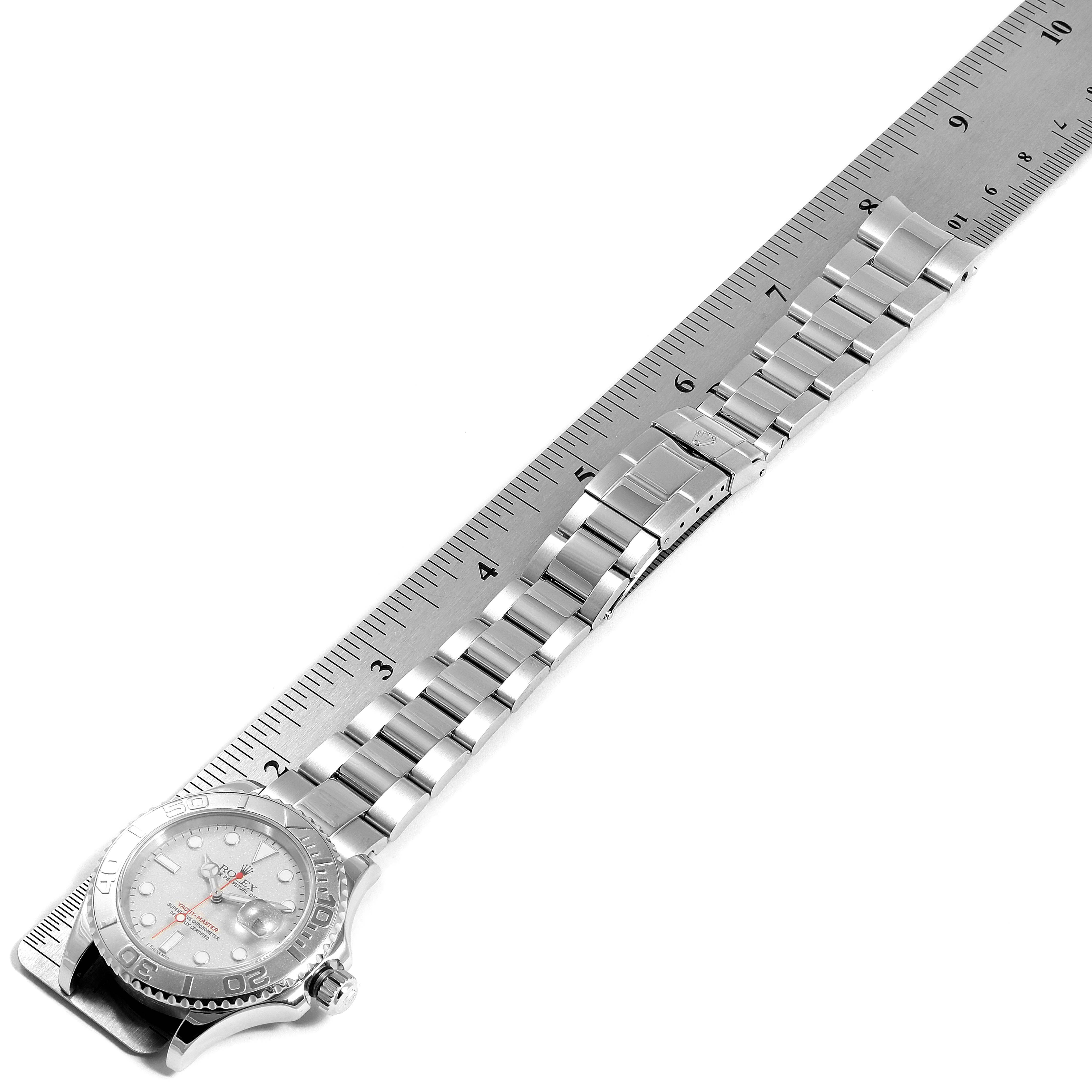 The image shows a top-down view of the Rolex Yacht-Master 16622 Men's Platinum Silver Dial 16622 Men's Platinum Silver Dial watch, displaying the face and entire metal bracelet length alongside a ruler.