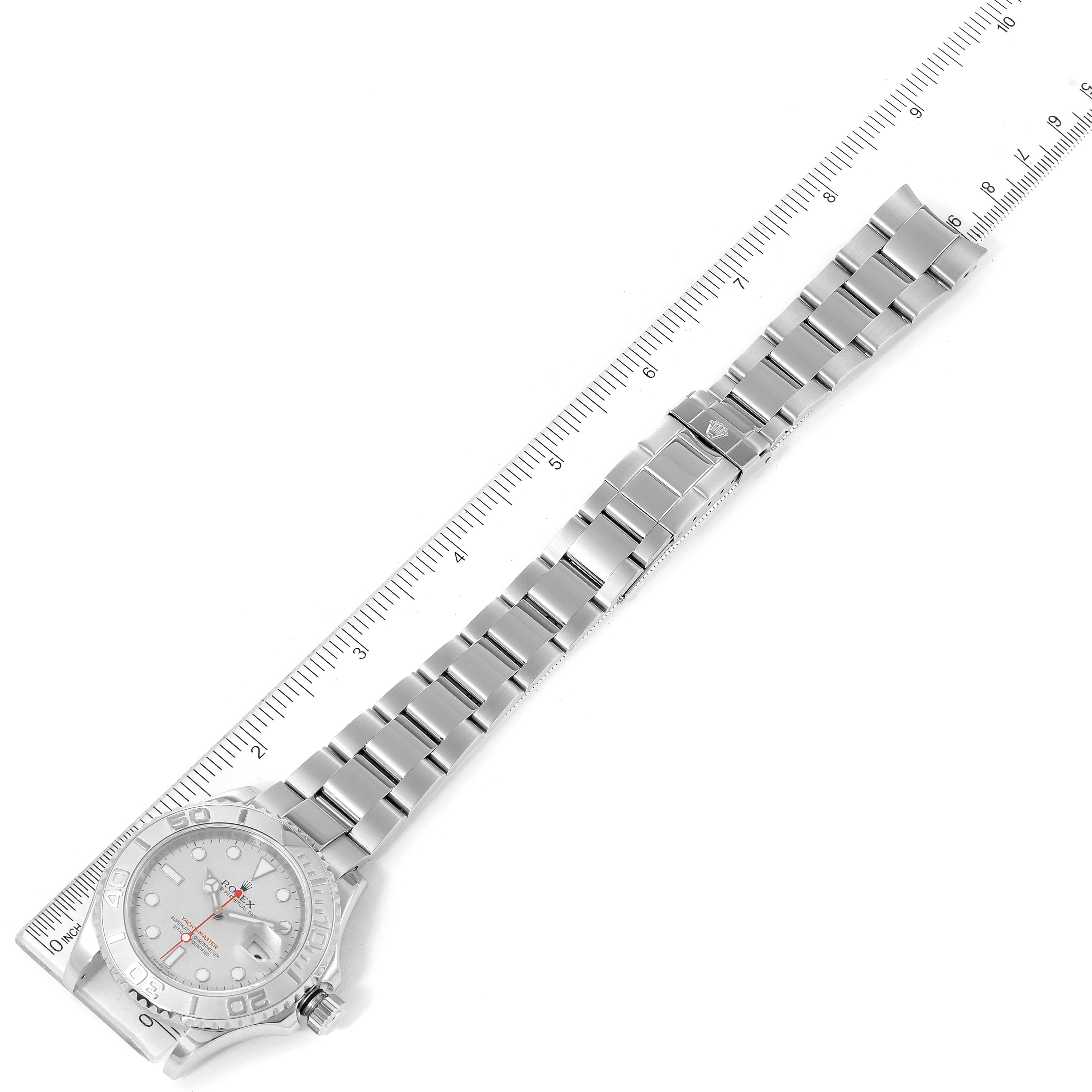 This image shows the Rolex Yacht-Master 16622 Men
s Stainless Steel Silver Dial 16622 Men
s Stainless Steel Silver Dial watch laid flat with its full bracelet band next to a ruler for scale.