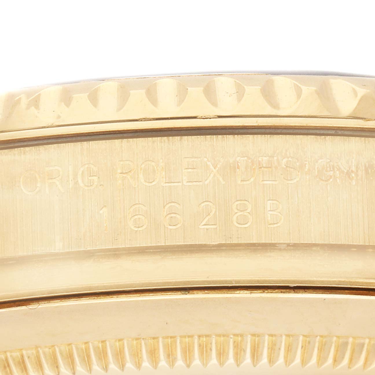 The image shows the side of the Rolex Yacht-Master 16628B Men
s Yellow Gold Mother of Pearl Dial
s case with engravings and part of the bezel.