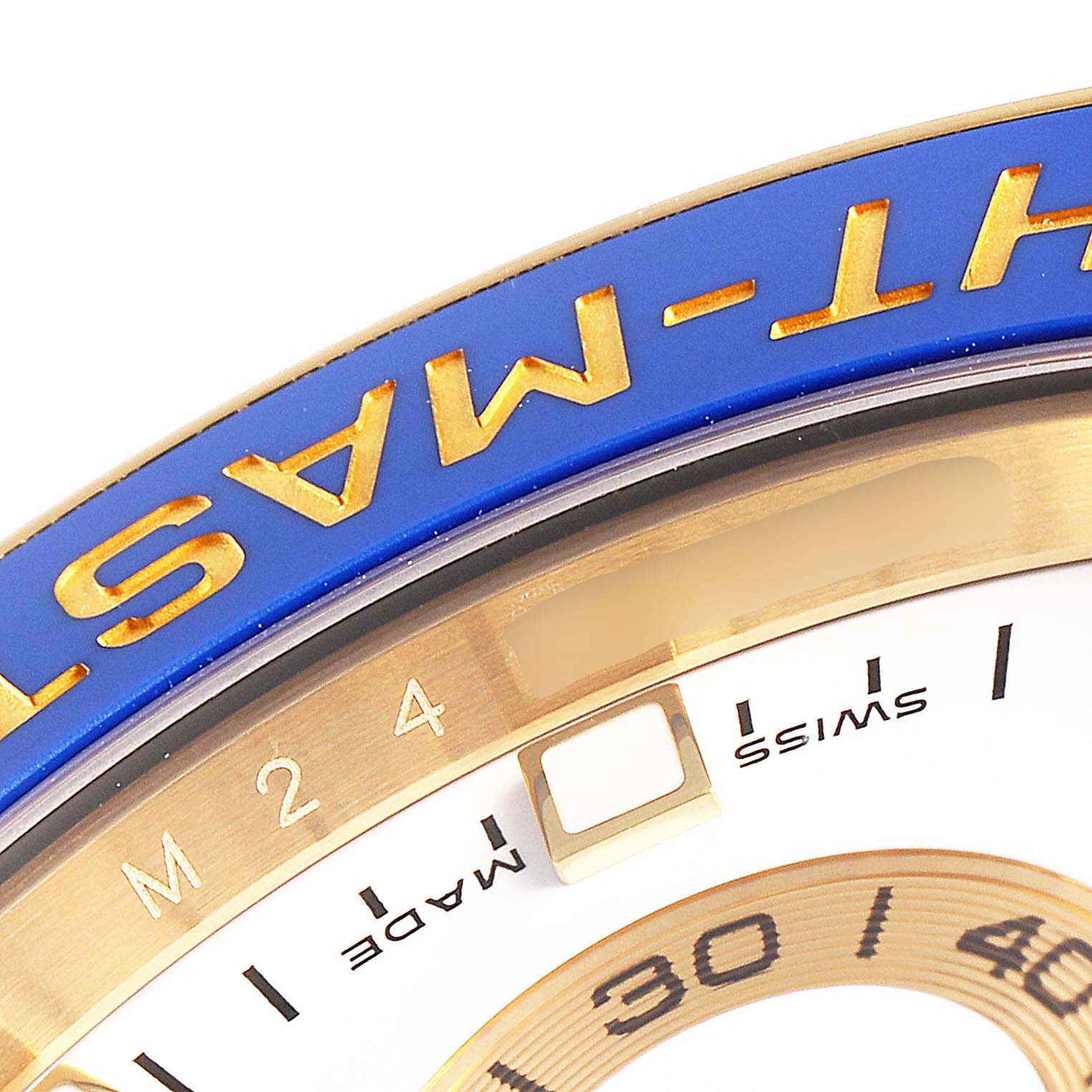 The image shows a close-up of the bezel and a portion of the dial of a Rolex Yacht-Master 116689 Men's Yellow Gold White Dial 116689 Men's Yellow Gold White Dial watch.