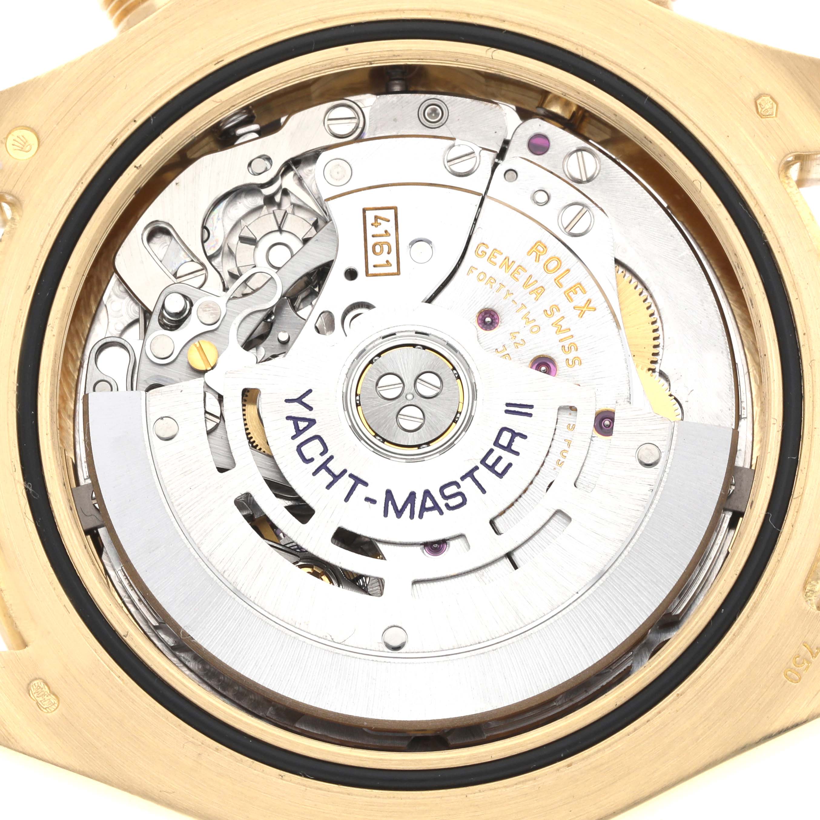 The image shows the internal mechanism of a Rolex Yacht-Master 116688 Men
s Yellow Gold White Dial watch, viewed from the back, highlighting the rotor and movement.