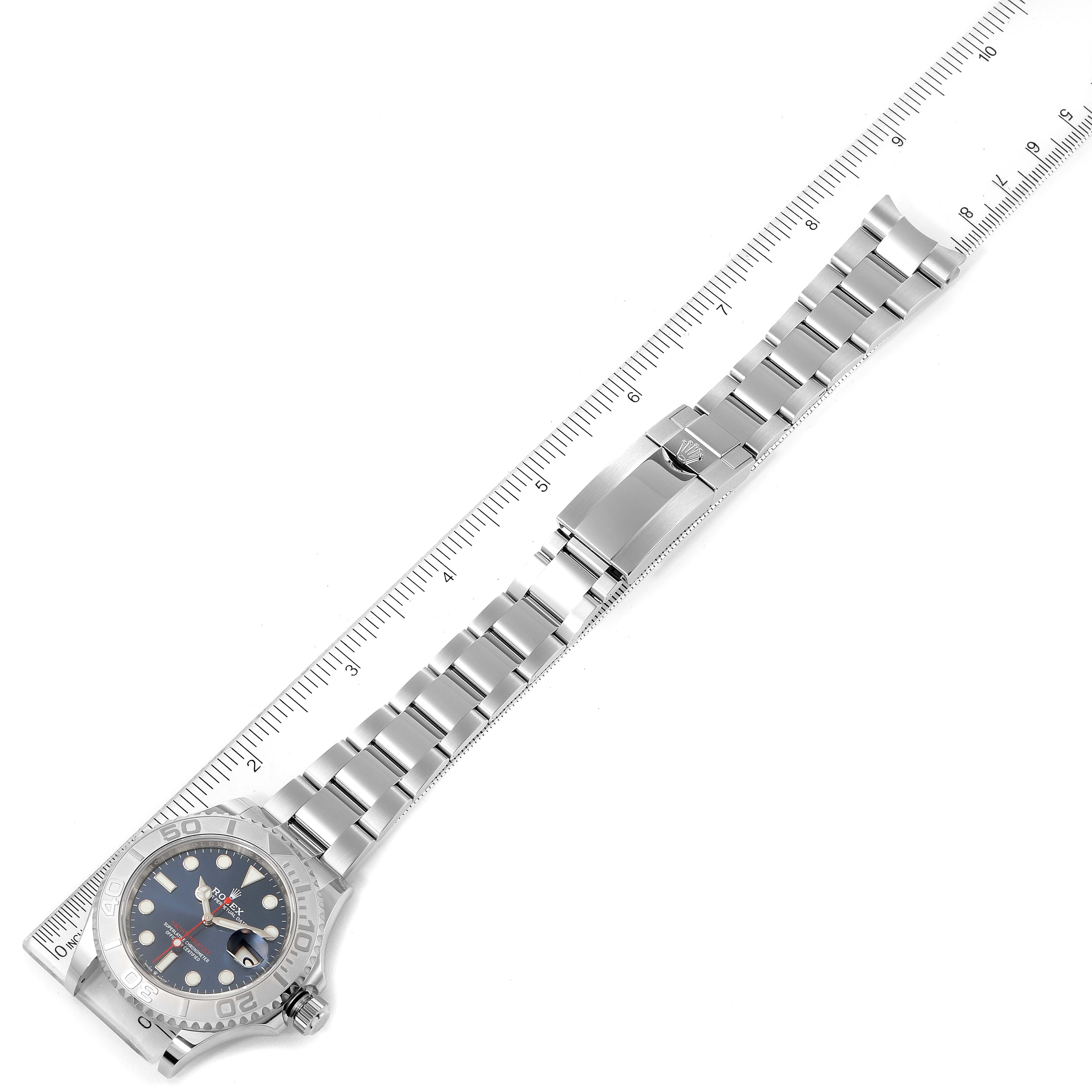 This image shows a Rolex Yacht-Master 126622 Men
s Stainless Steel Blue Dial 126622 Men
s Stainless Steel Blue Dial watch laid flat next to a ruler, displaying the entire bracelet and clasp.