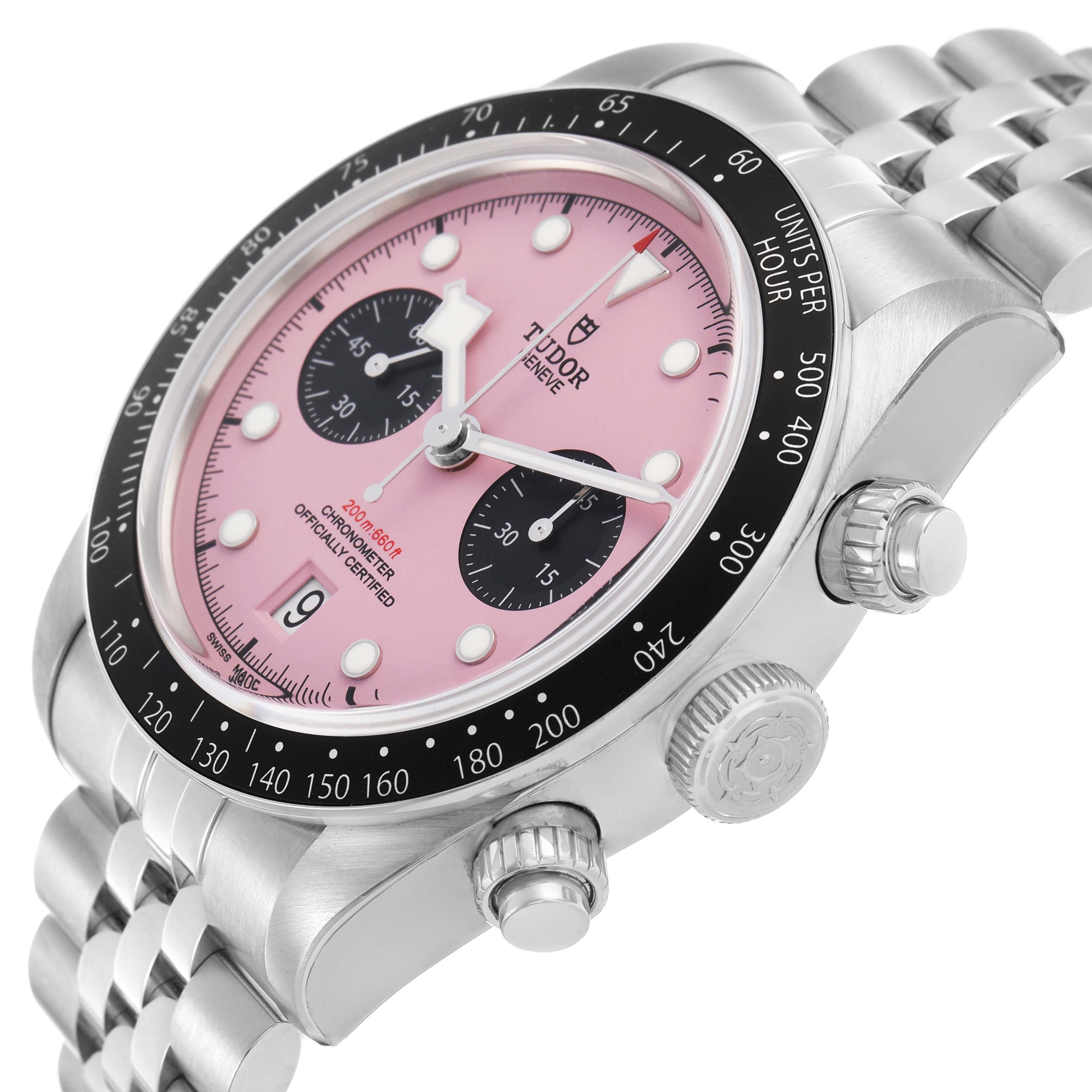 The Tudor Heritage Black Bay M79360N Men's Stainless Steel Pink Dial watch is shown at an angle highlighting the dial, bezel, crown, and bracelet.