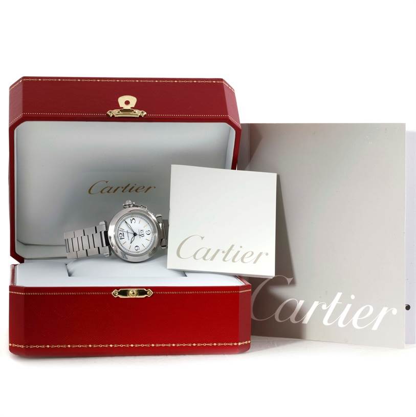 The Cartier Pasha W31044M7 Men
s Stainless Steel Silver Dial W31044M7 Men
s Stainless Steel Silver Dial watch is displayed front-facing within its open red case alongside branded documentation.